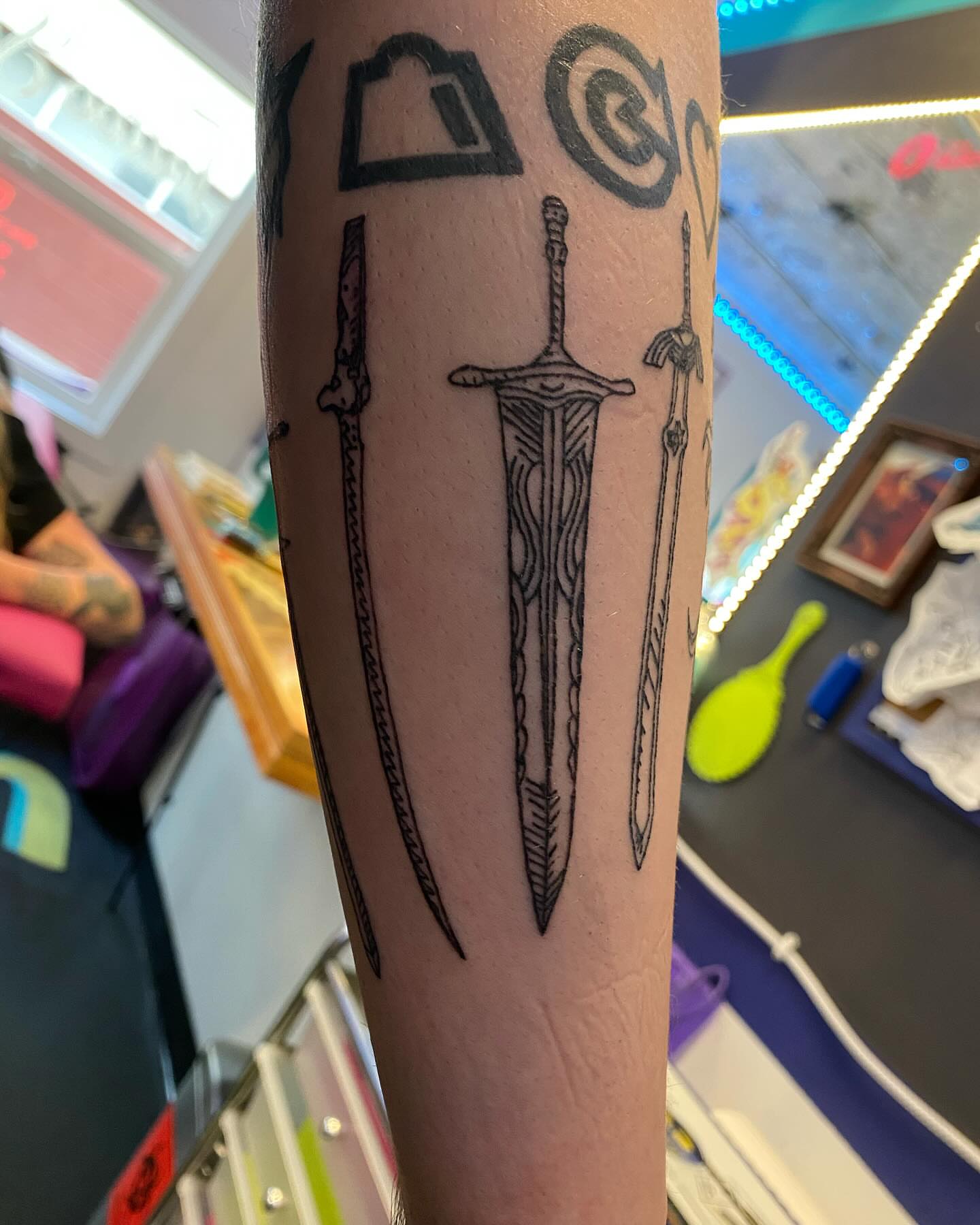 Three swords black and grey tattoo on the forearm by Tesla Kohl