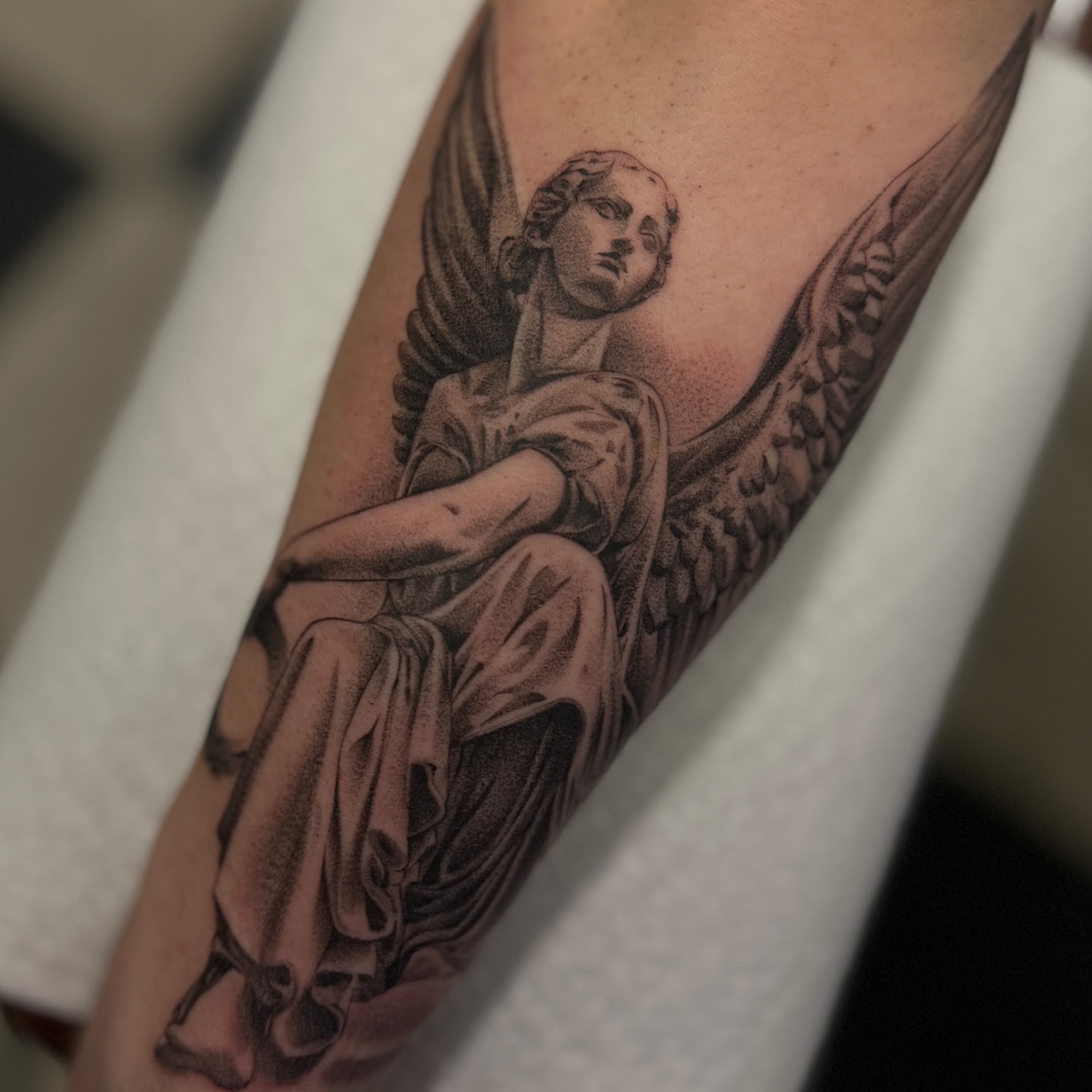 Angel realism tattoo on the forearm by Zachary Kaufhold