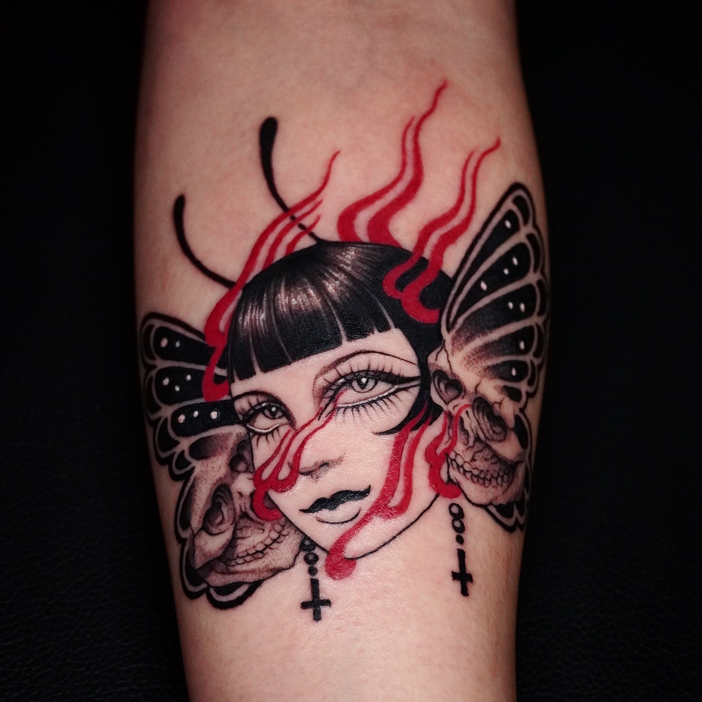 Woman with skulls dark realism tattoo on the forearm by 吳盈慧, Los Angeles, California