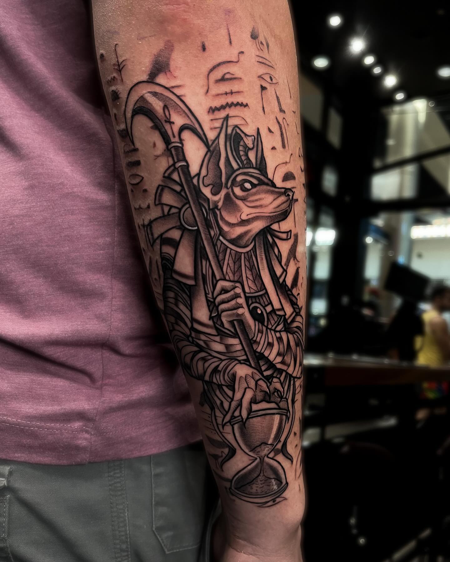 Ancient god with hourglass realism tattoo on the forearm by Demi DiMartino
