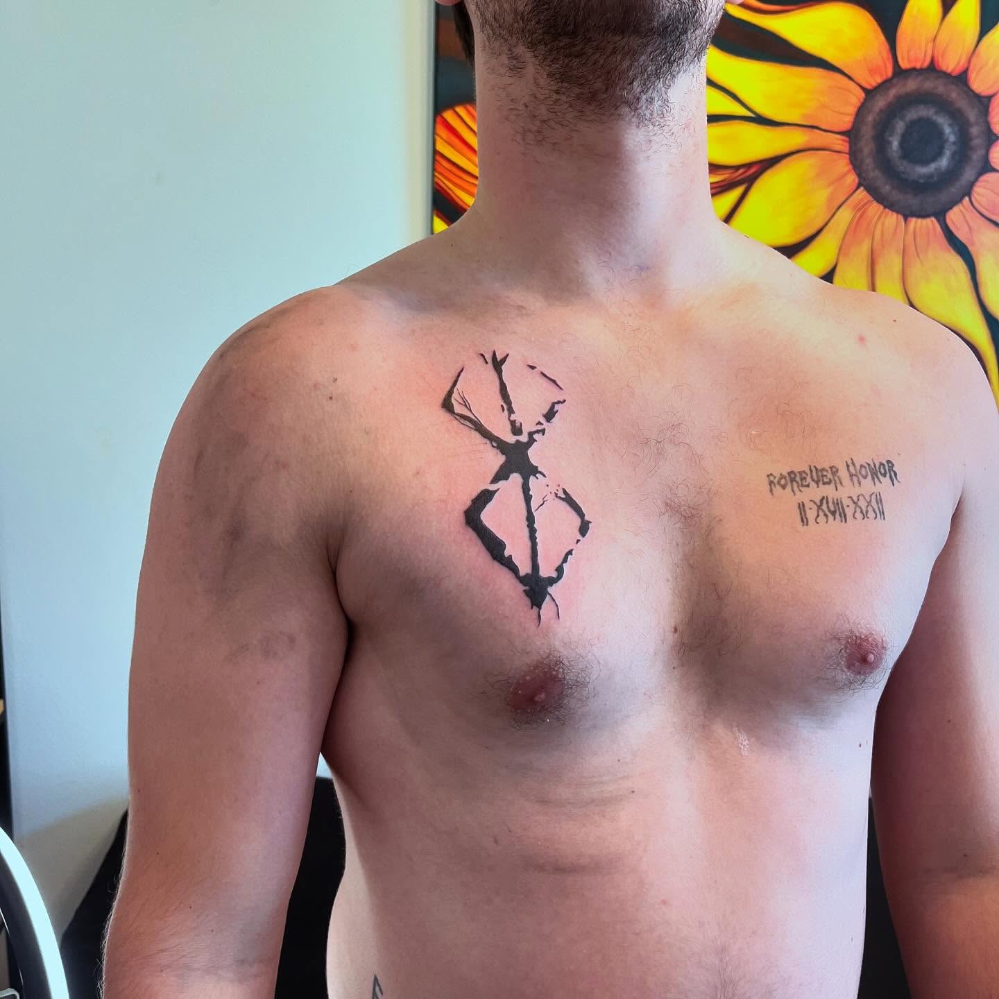 Geometric symbol geometric tattoo on the chest by Val Maughan