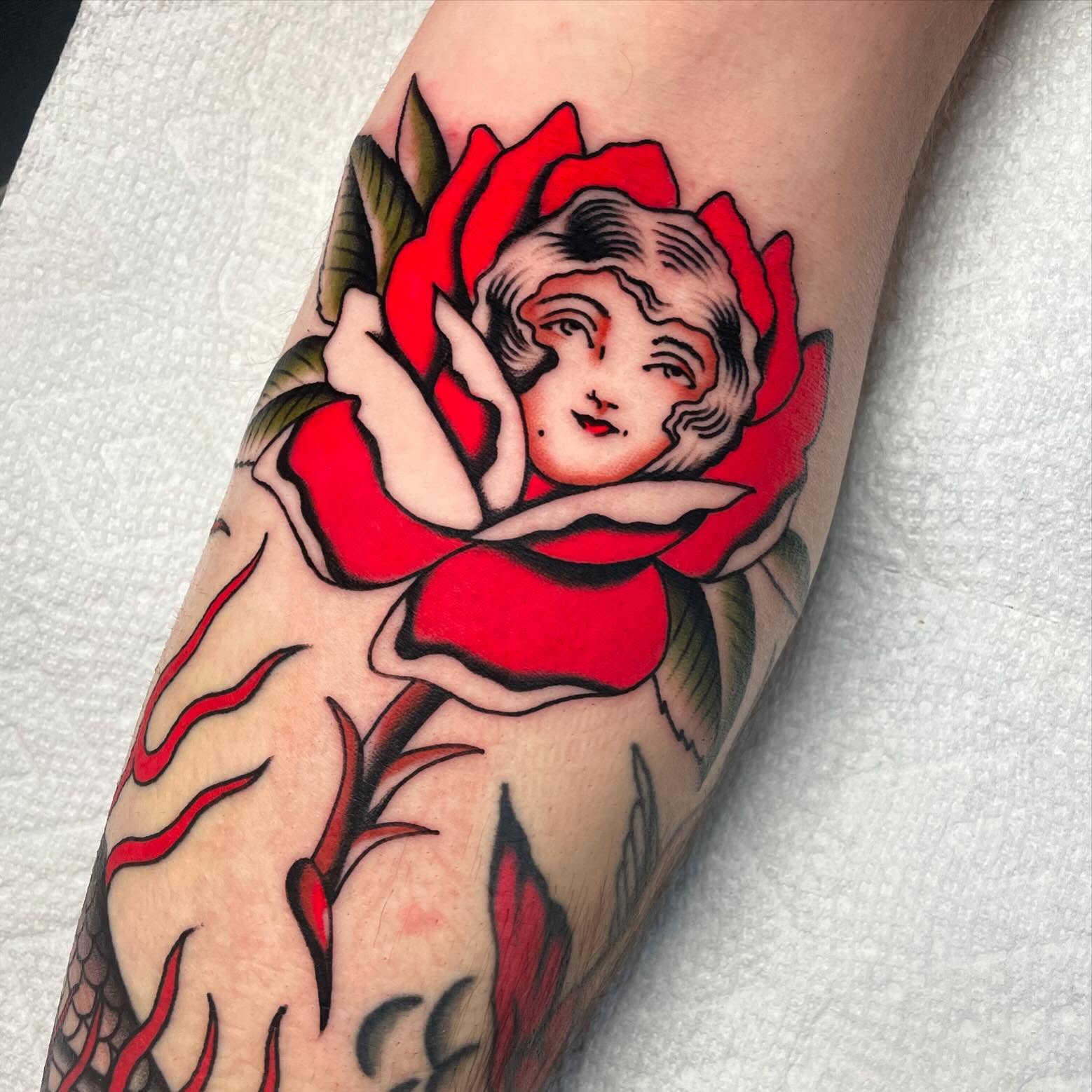 Woman in rose American traditional tattoo on the forearm by Toulouse Noble, Portland, Oregon