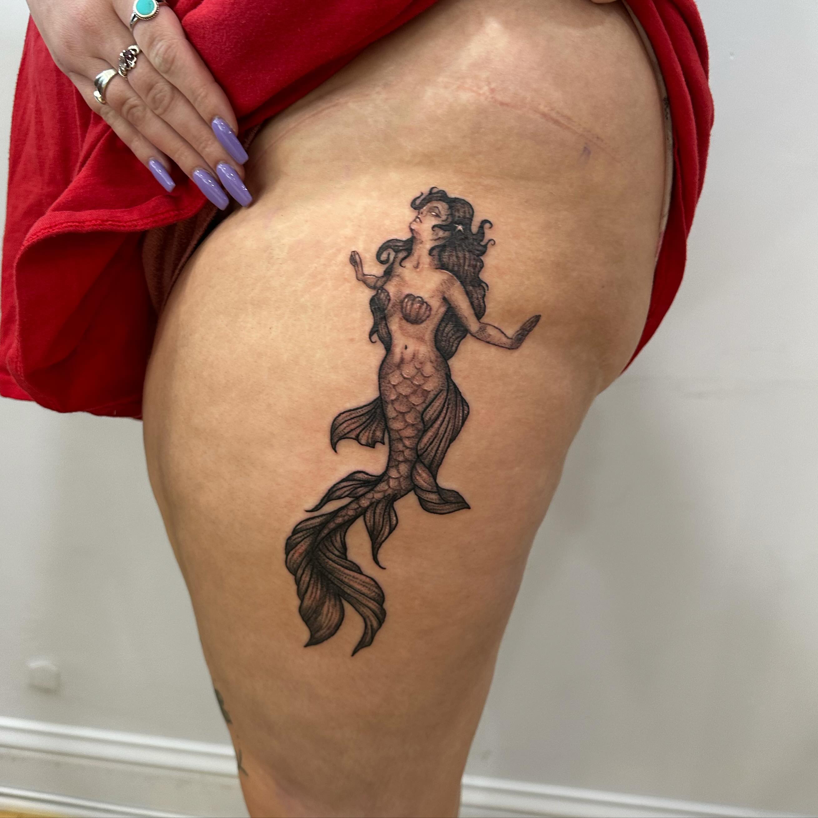 Mermaid black and grey tattoo on the thigh by Emma