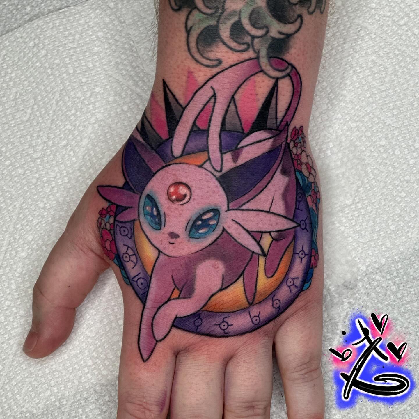 Mysterious creature geometric tattoo on the hand by Keyon J