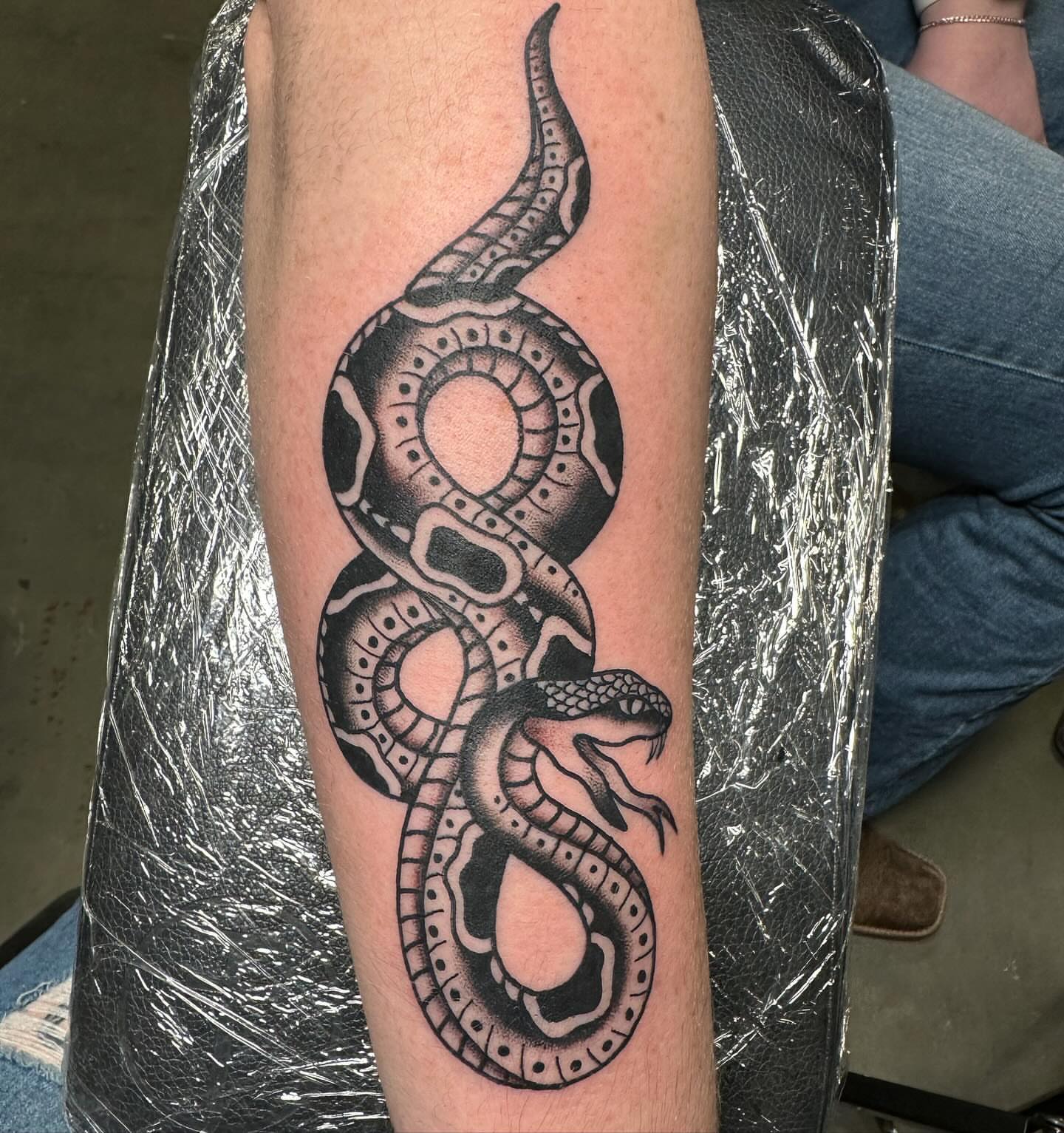 Snake black and grey tattoo on the forearm by Jess Ritchie, Austin, Texas