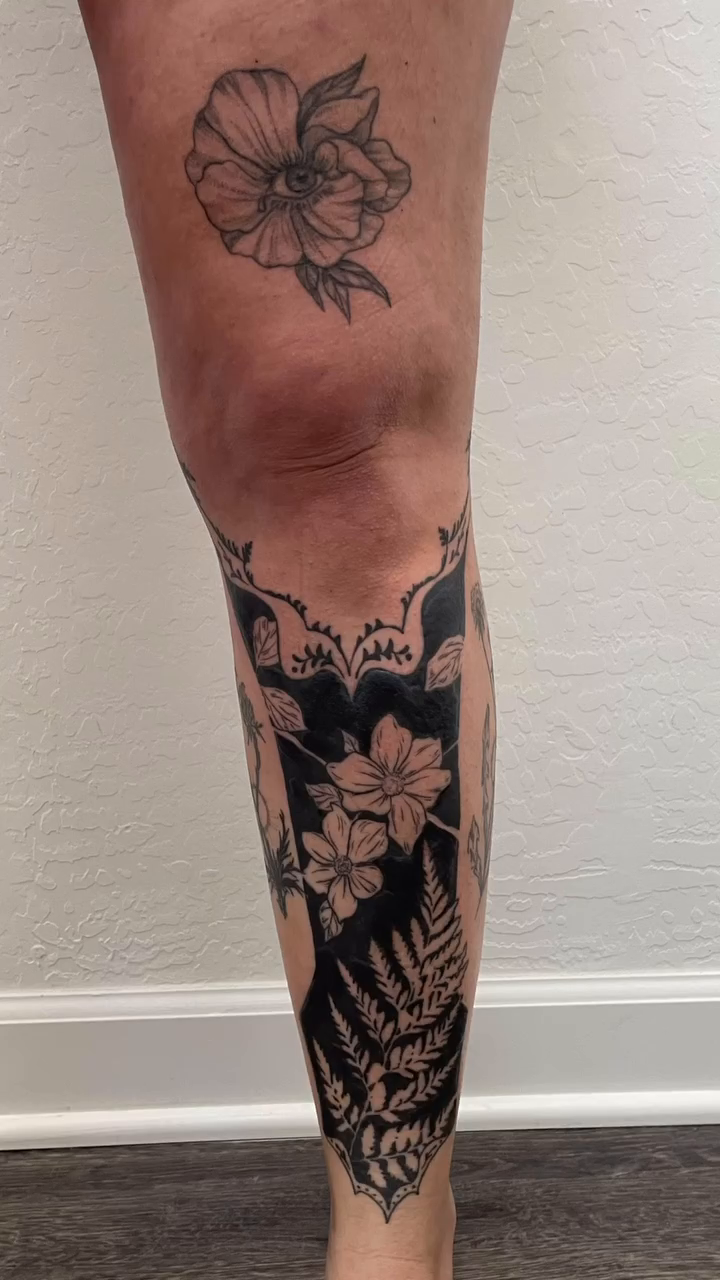Floral leg sleeve with blackwork elements Japanese tattoo on the calf by Thylacine Tattoo & Art, Los Angeles, California