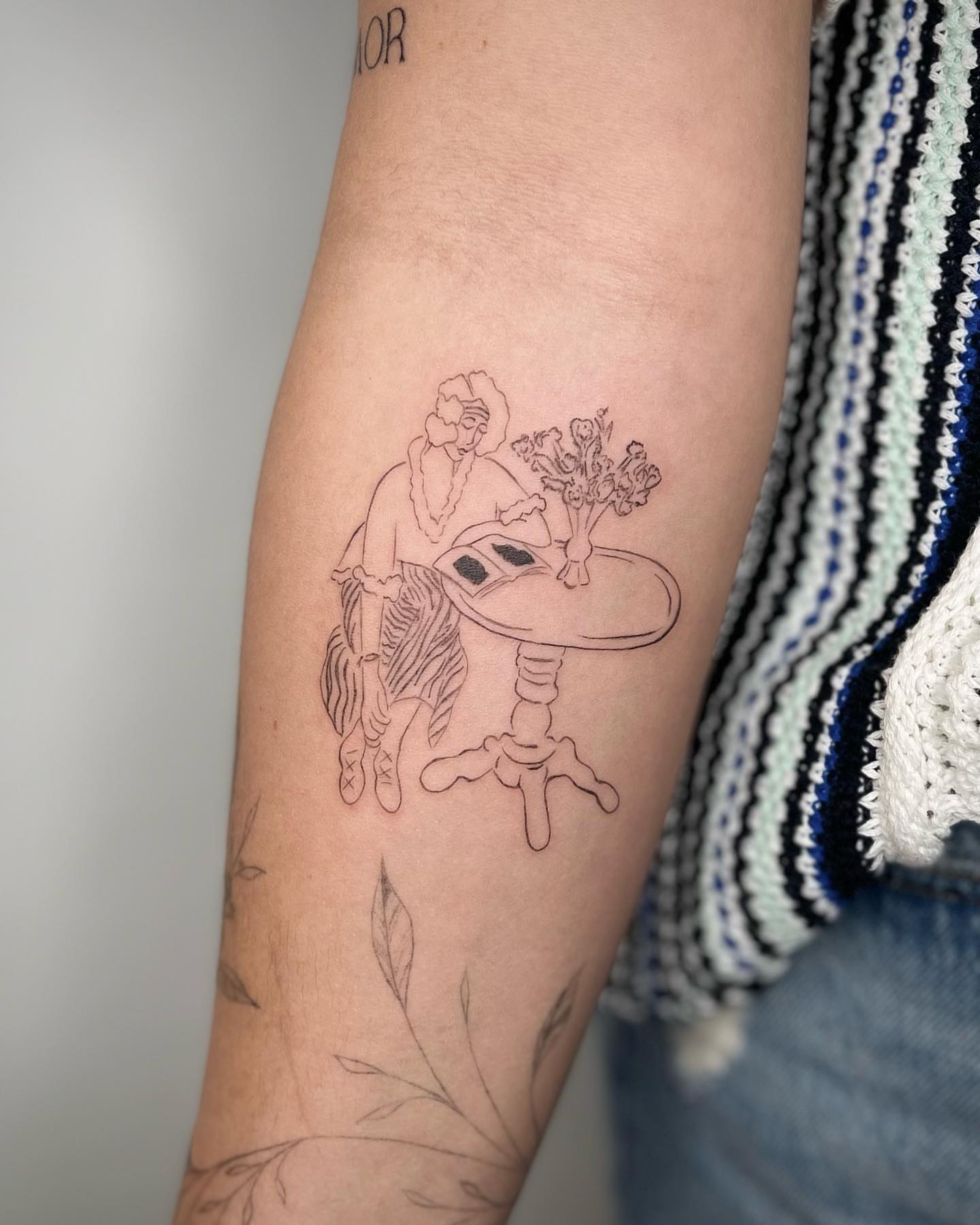 Woman with hat black and grey tattoo on the forearm by Jennifer Fuster