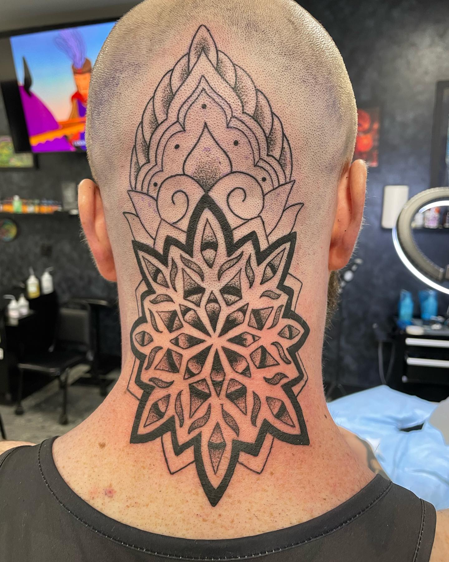 Geometric mandala dotwork tattoo on the neck by Brandon Anderson