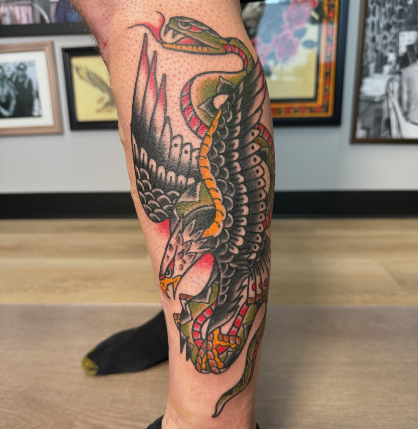 Snake and peony American traditional tattoo on the forearm by Jeremy Hudson