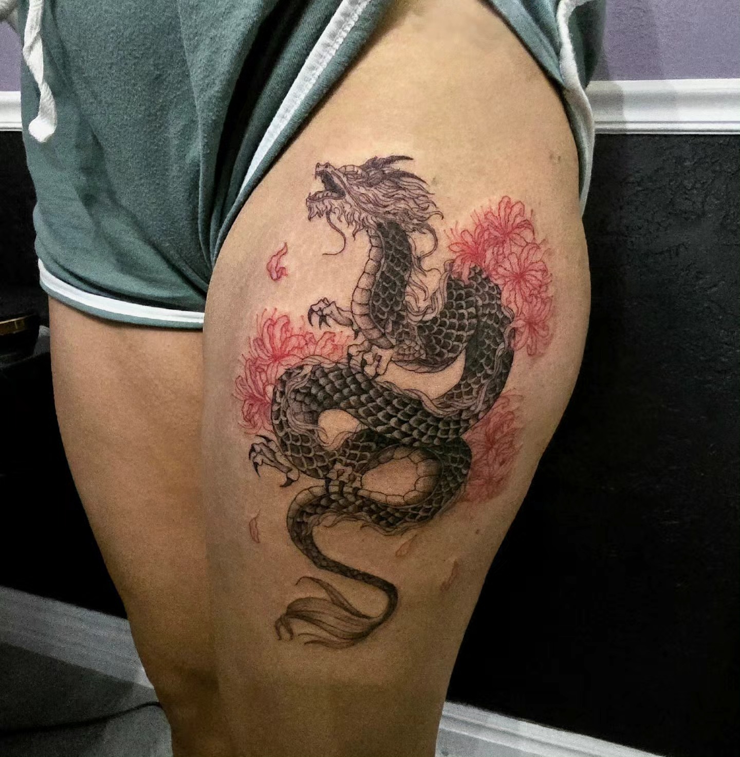 Dragon and flowers japanese irezumi tattoo on the thigh by Utah Tattoo Artist
