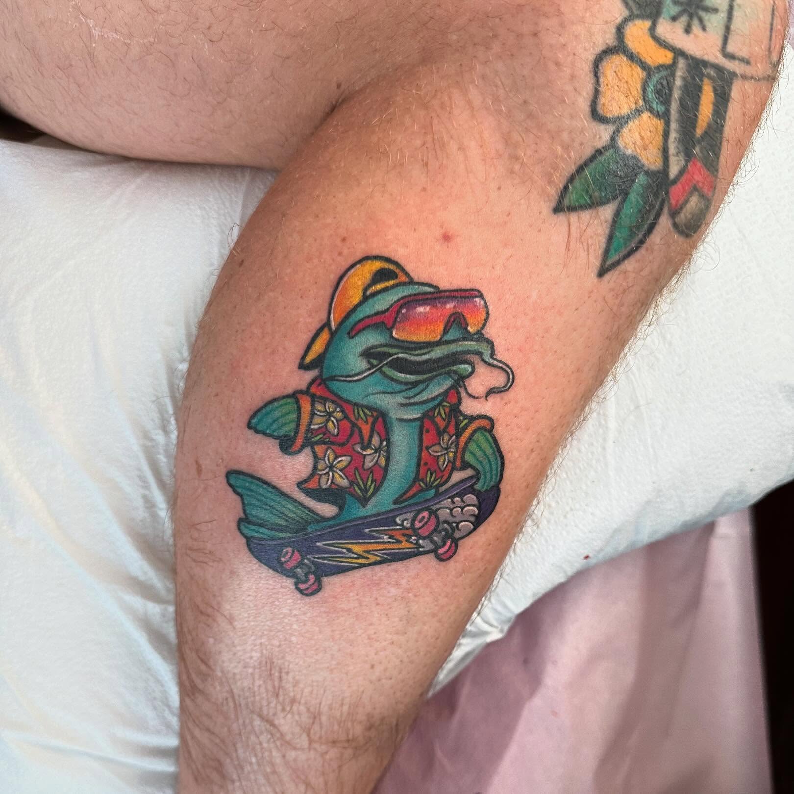 Dolphin new school tattoo on the forearm by Erin Miller