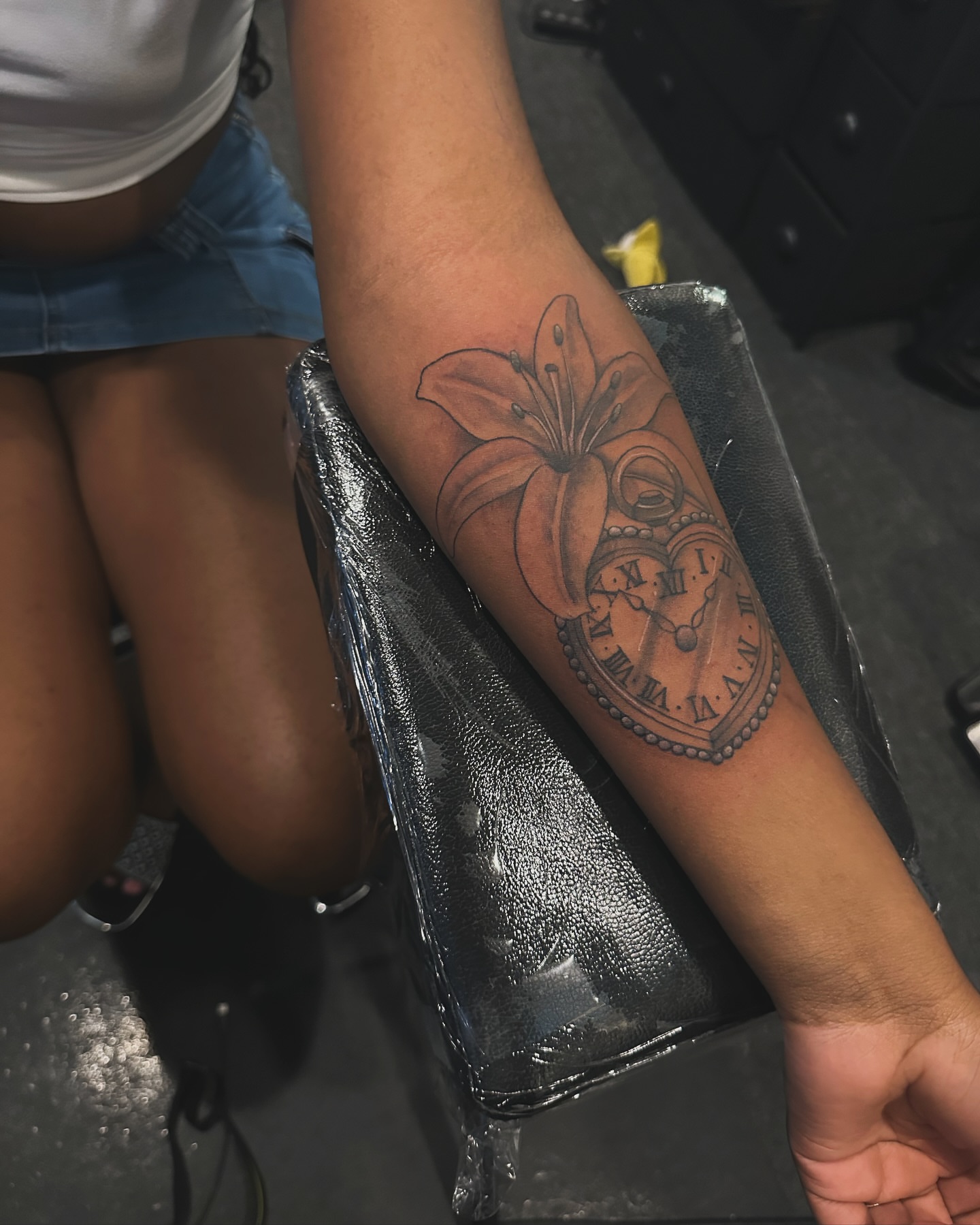 Lily and clock black and grey tattoo on the forearm by 2realink - Tattoo Artist