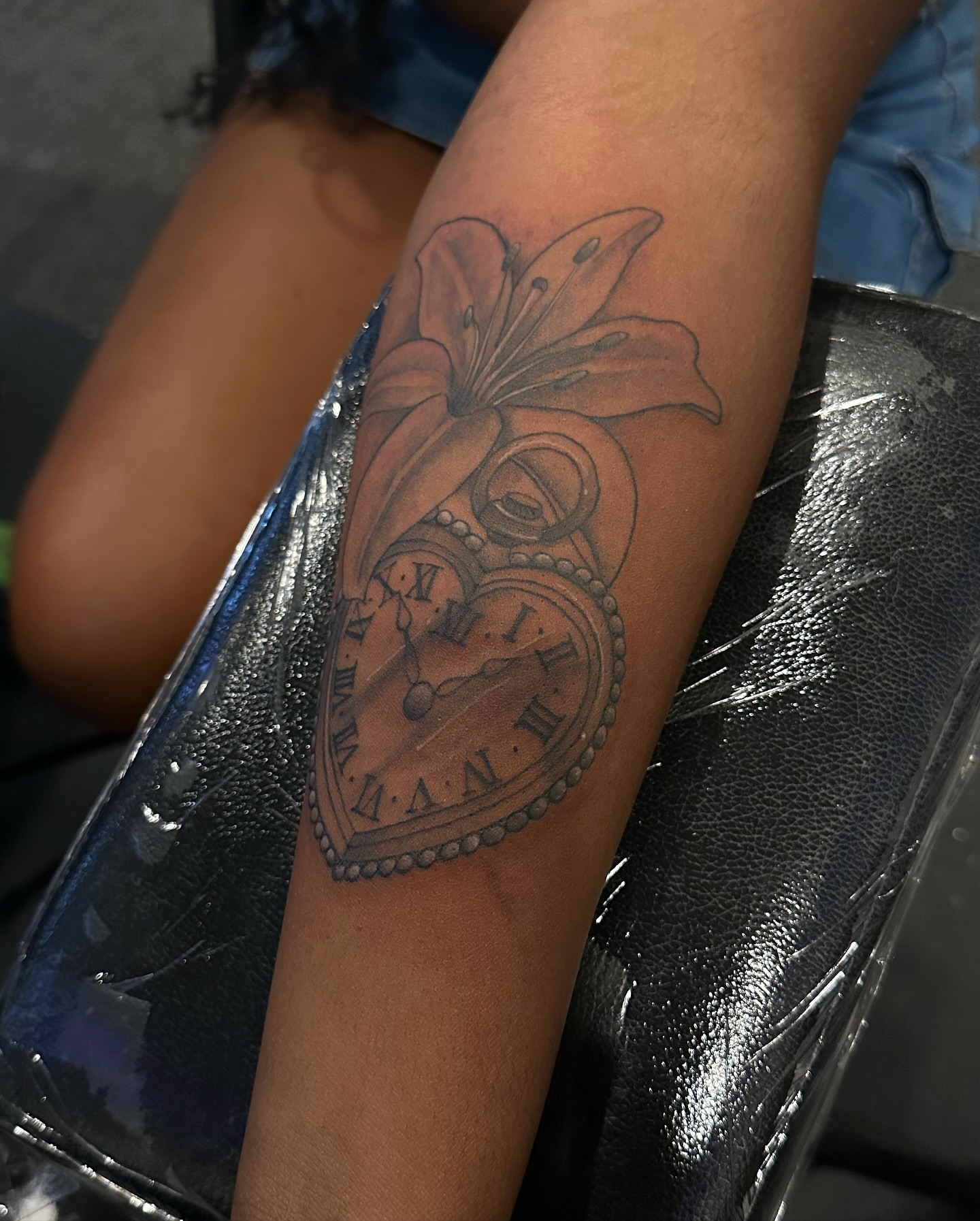 Lily and clock black and grey tattoo on the forearm by 2realink - Tattoo Artist