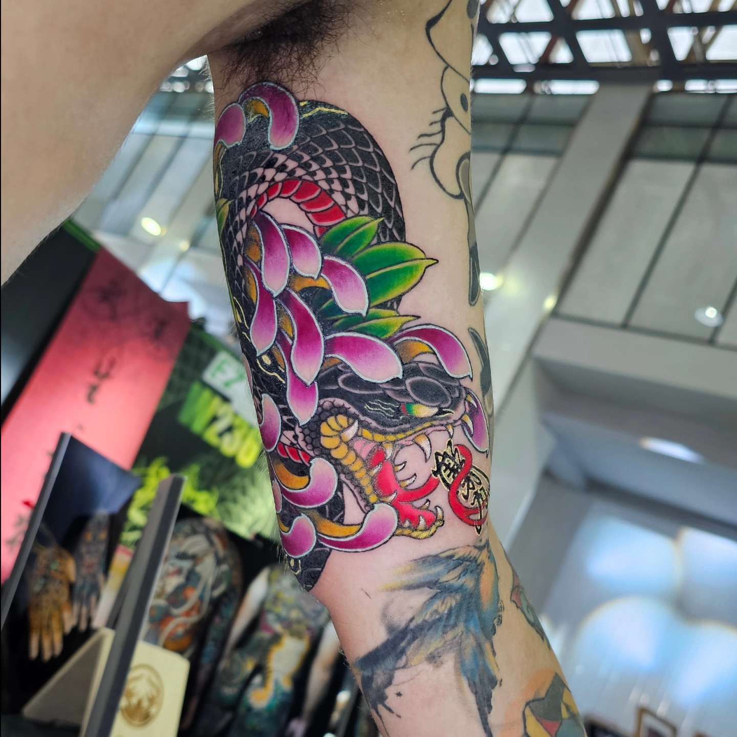 Snake and peony japanese irezumi tattoo on the forearm by 彫かか