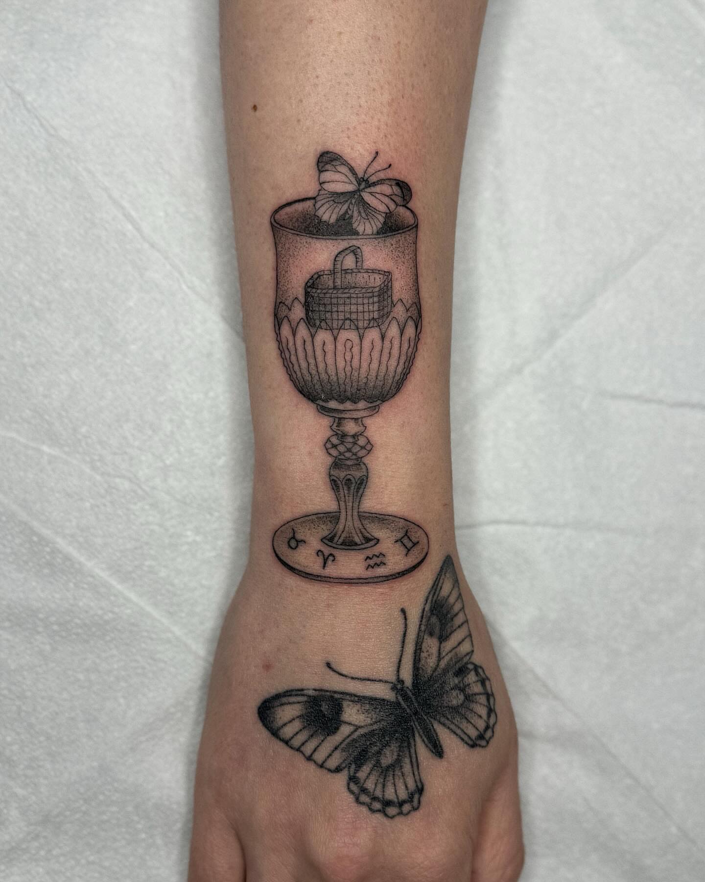 Chalice and butterfly realism tattoo on the forearm by Finley Jordan