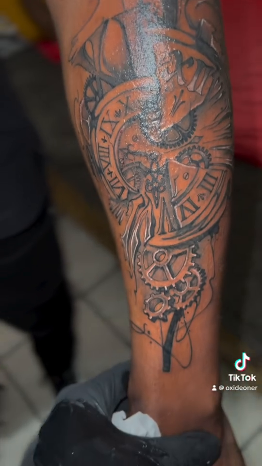 Clockwork angel with gears realism tattoo on the upper arm by oxideTattoo, Morne-à-l'Eau