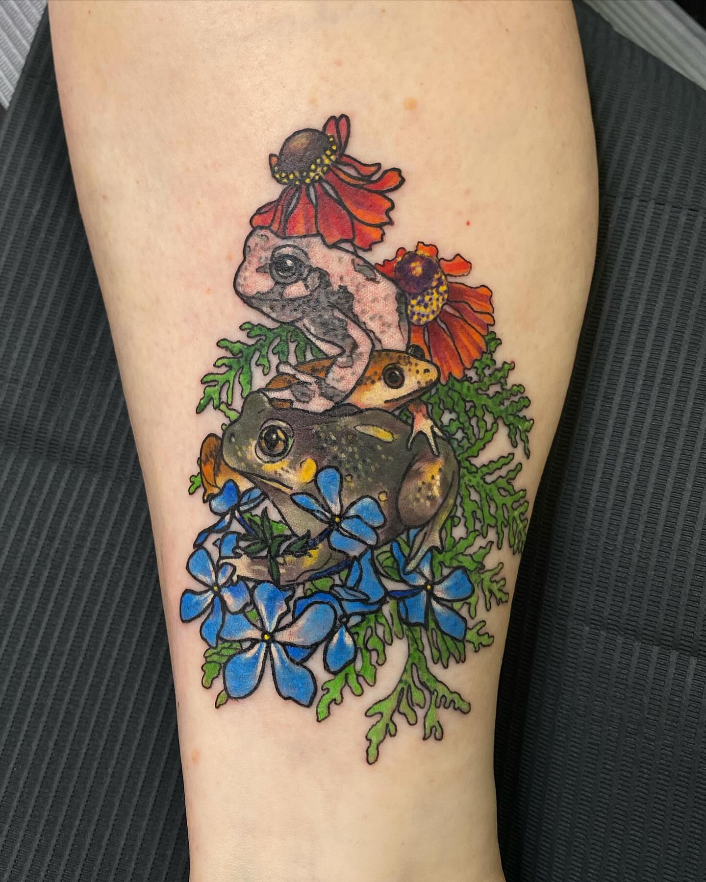 Frogs and flowers realism tattoo on the forearm by @kaitlin.tattoos, Richmond, Virginia