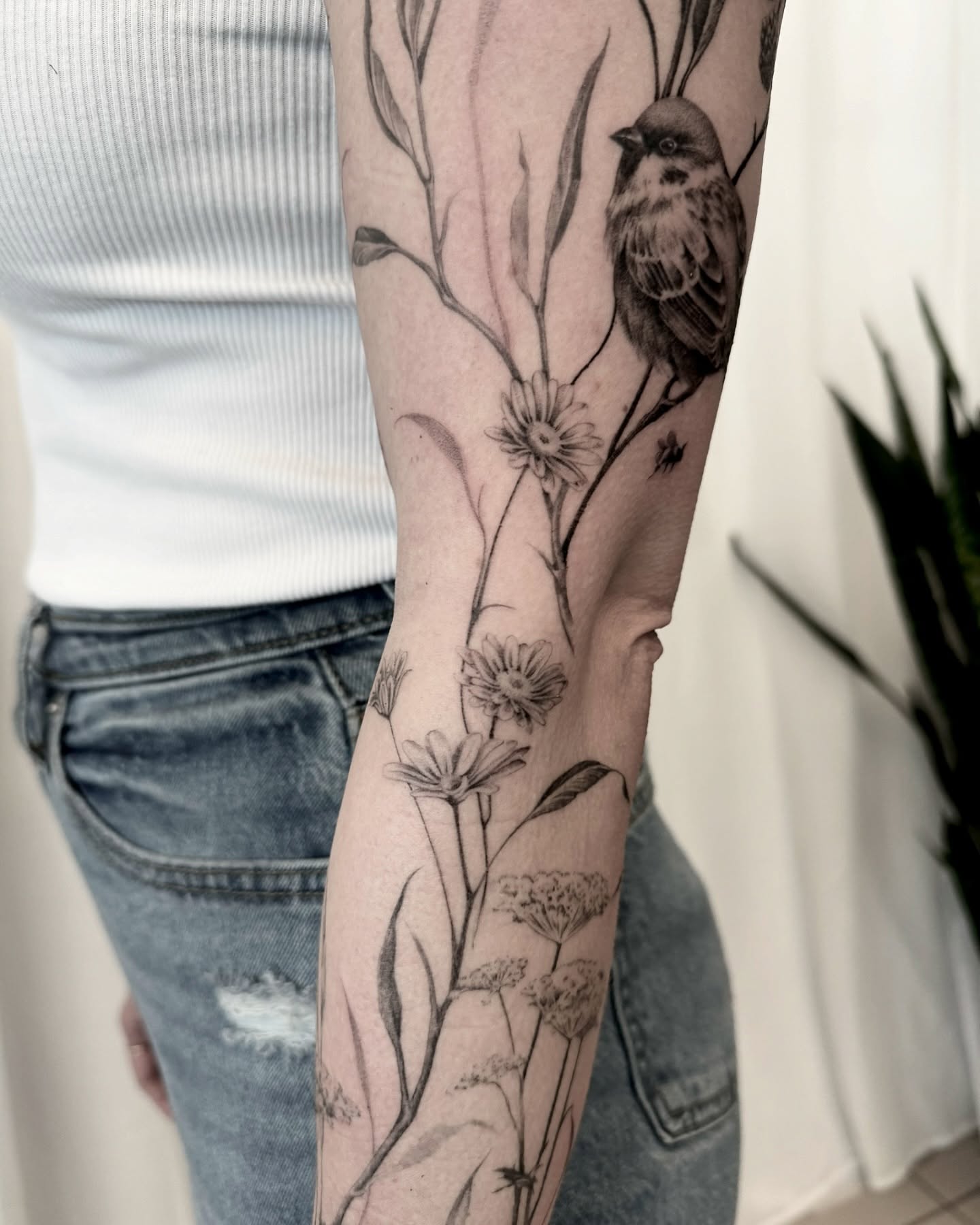 Bird and flowers realism tattoo on the forearm by Oori