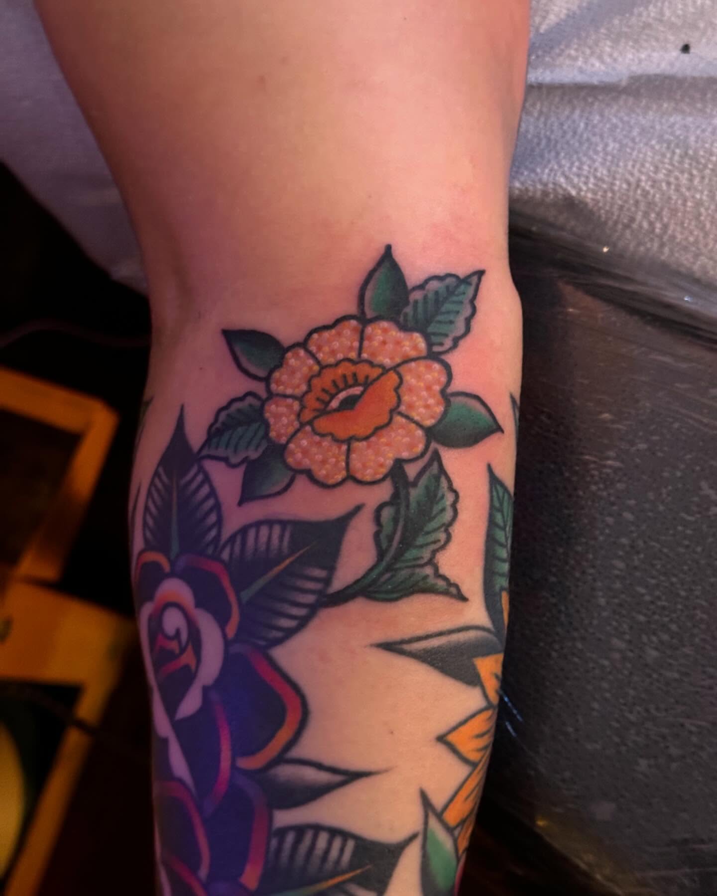 Floral bouquet American traditional tattoo on the forearm by Erin Miller