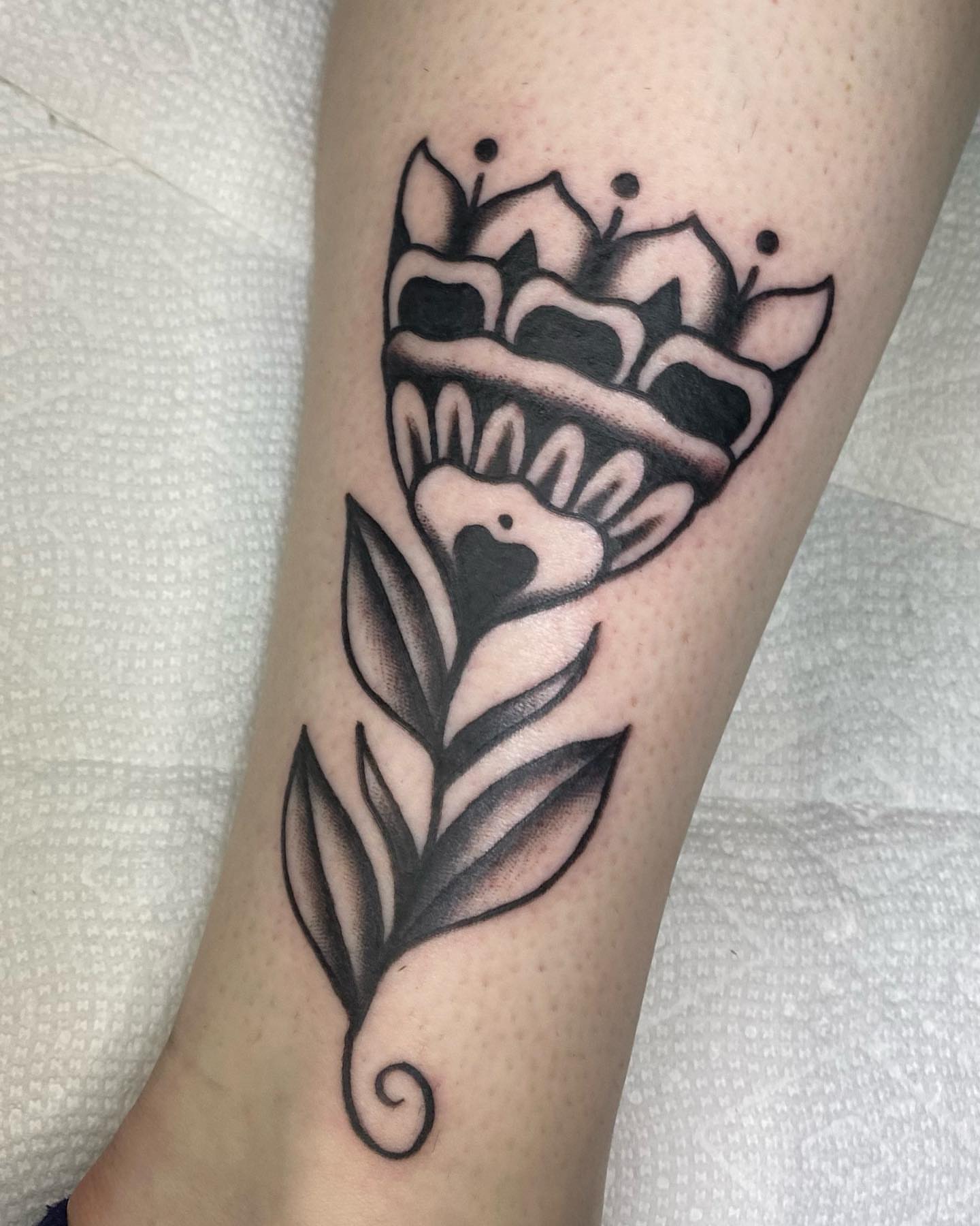 Flower bouquet black and grey tattoo on the forearm by Shana