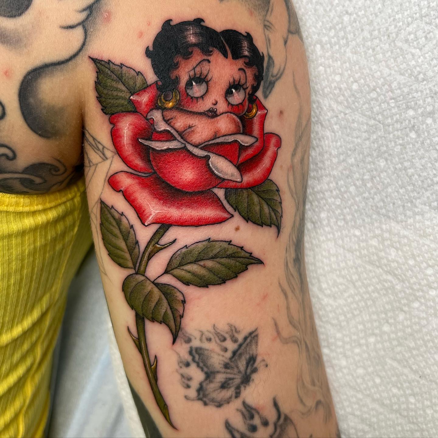 Betty boop in rose American traditional tattoo on the forearm by Valerie Dominguez