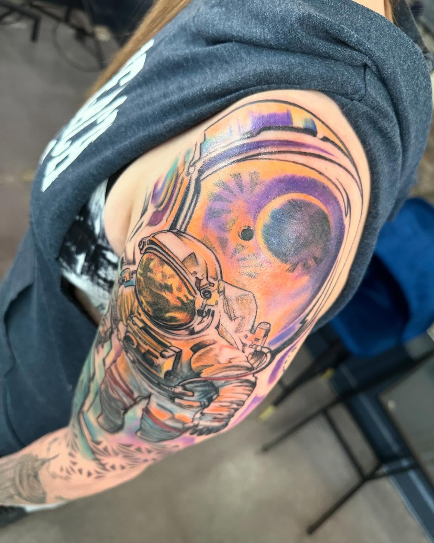 Astronaut helmet dotwork tattoo on the upper arm by Cameron Hobbs, Woodbridge, Virginia