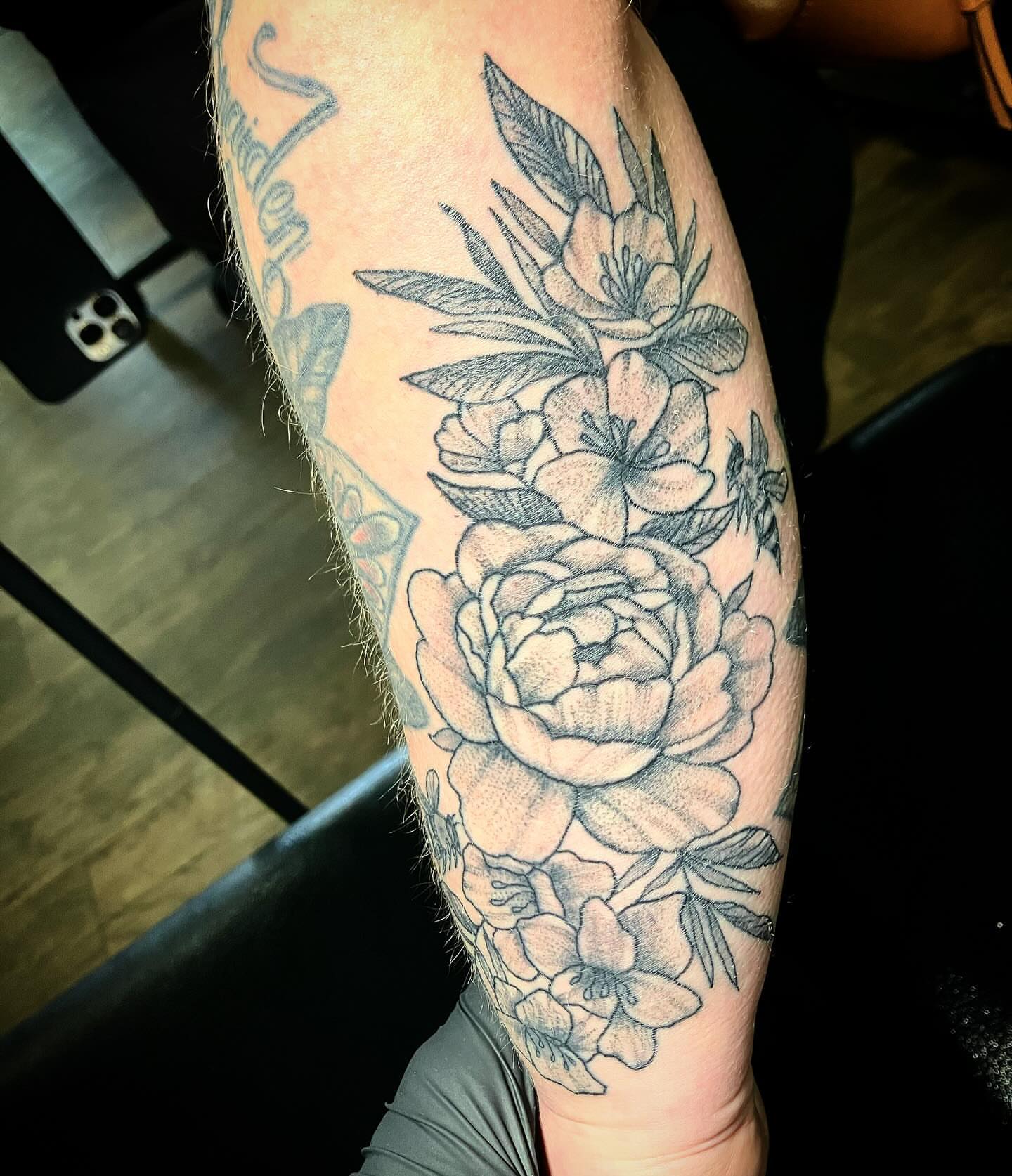 Floral arrangement realism tattoo on the forearm by Madeline, Akron, Ohio