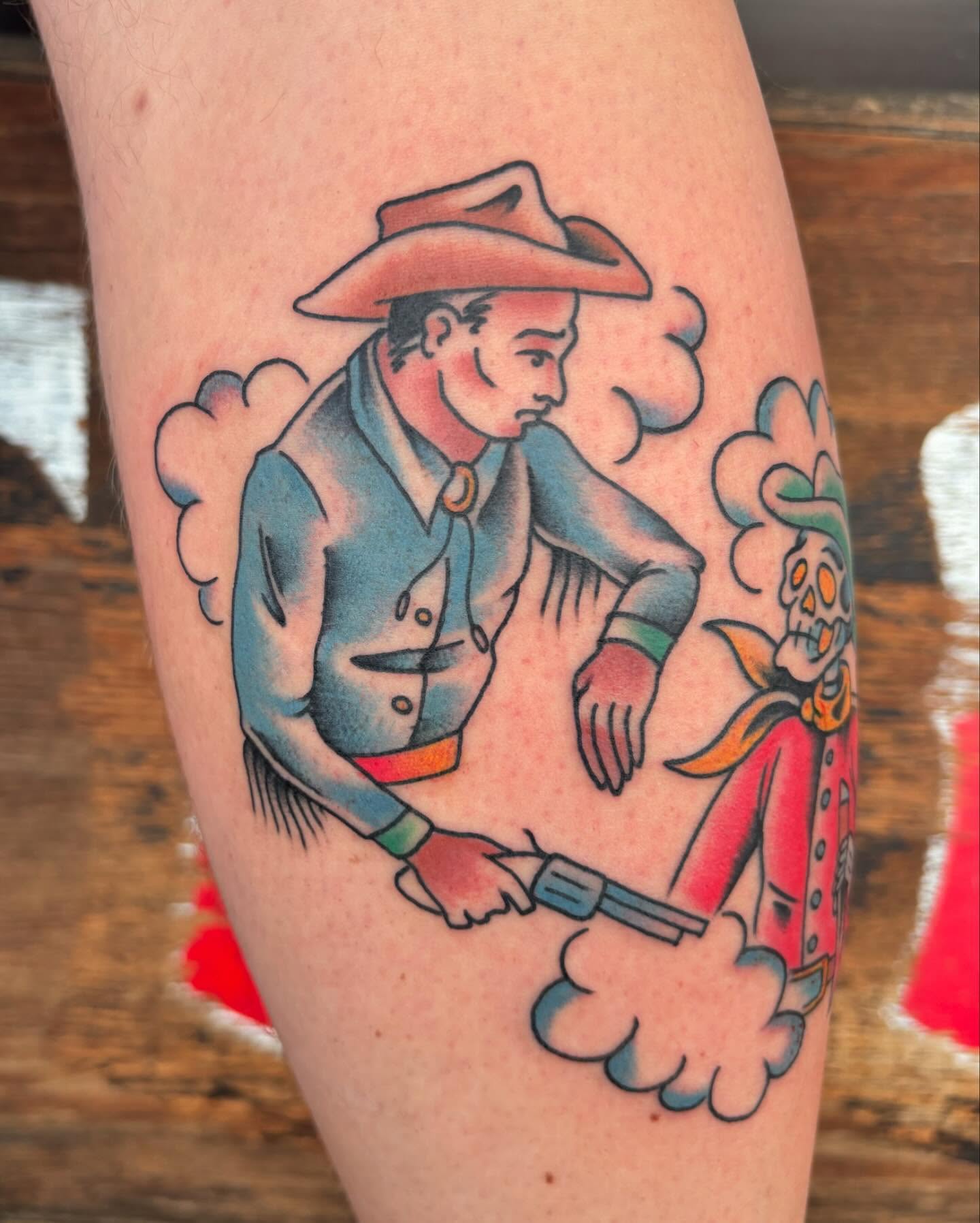 Cowboy shooting a gun American traditional tattoo on the forearm by Jordan Wray