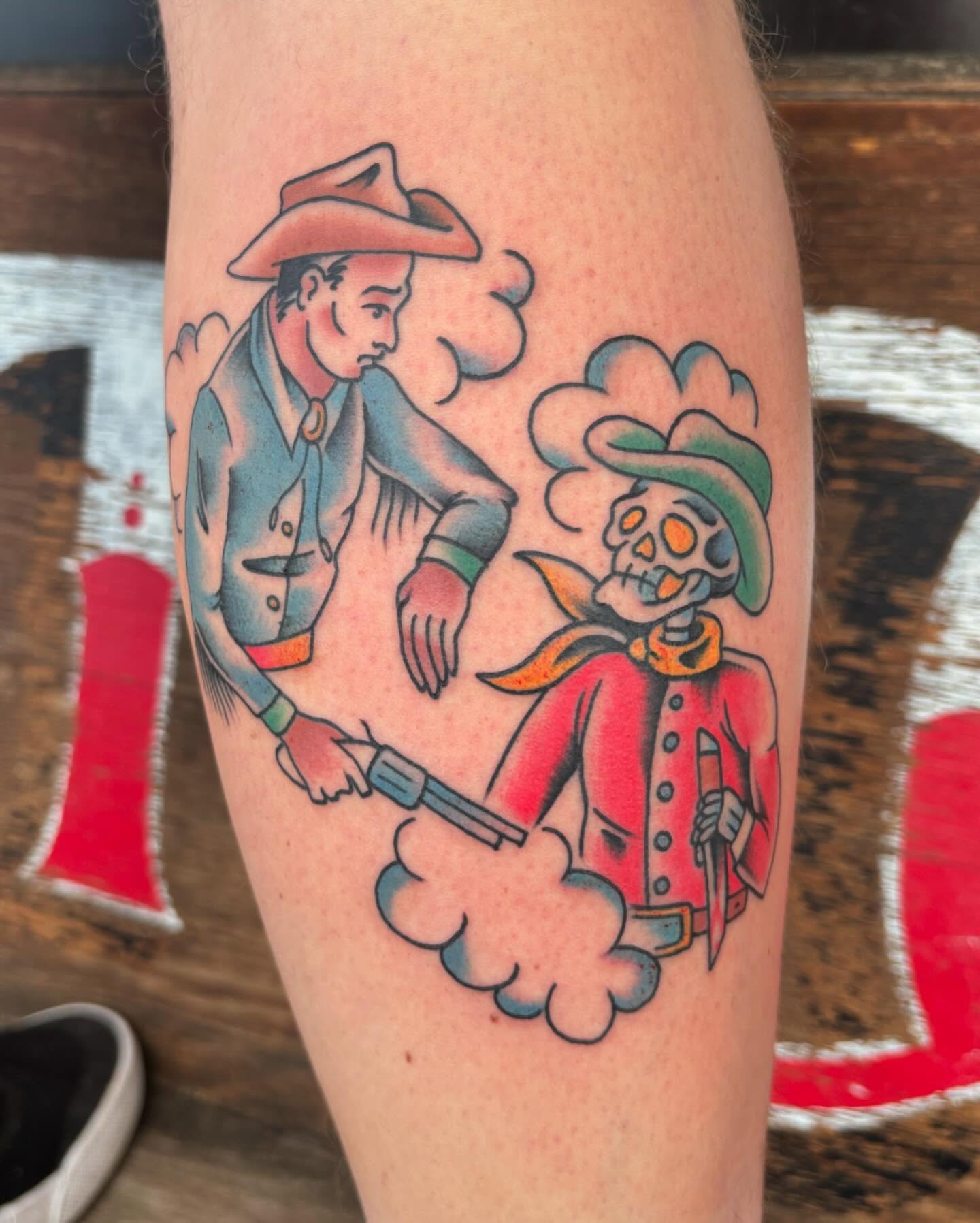 Cowboy and skeleton duel American traditional tattoo on the forearm by Jordan Wray