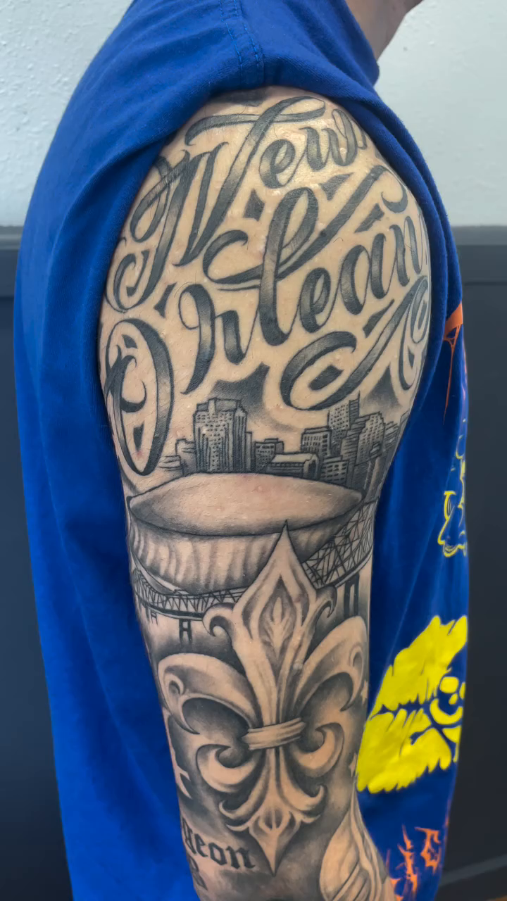 Script and fleur-de-lis lettering script tattoo by Blake