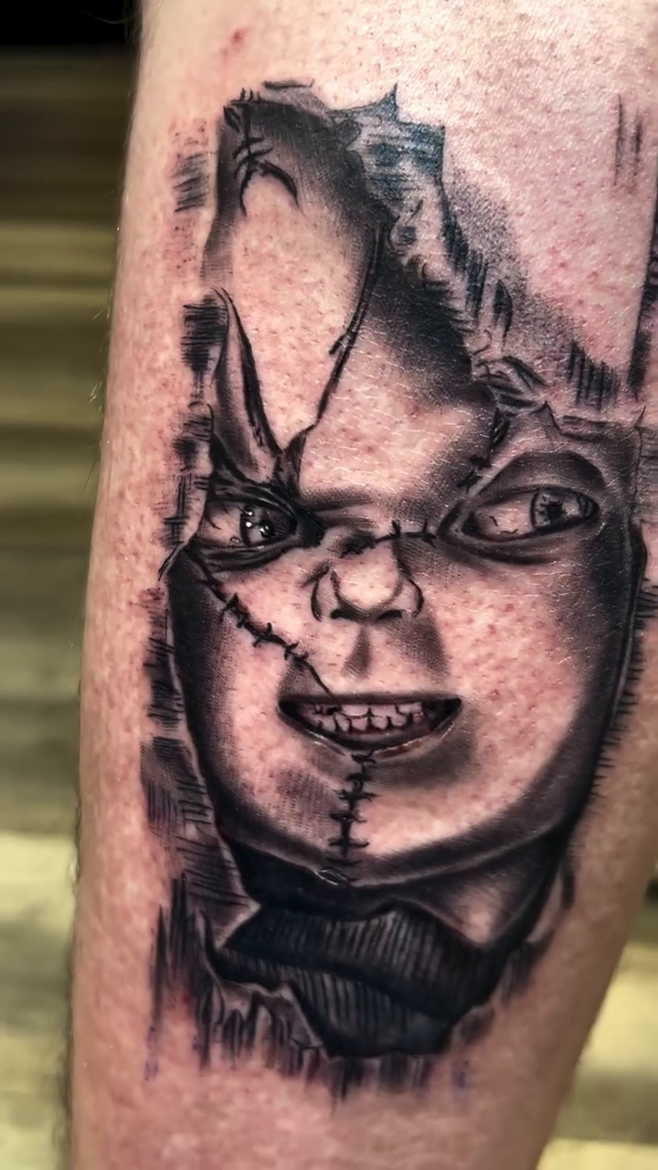 Chucky doll face realism tattoo by Kevyn Vidal