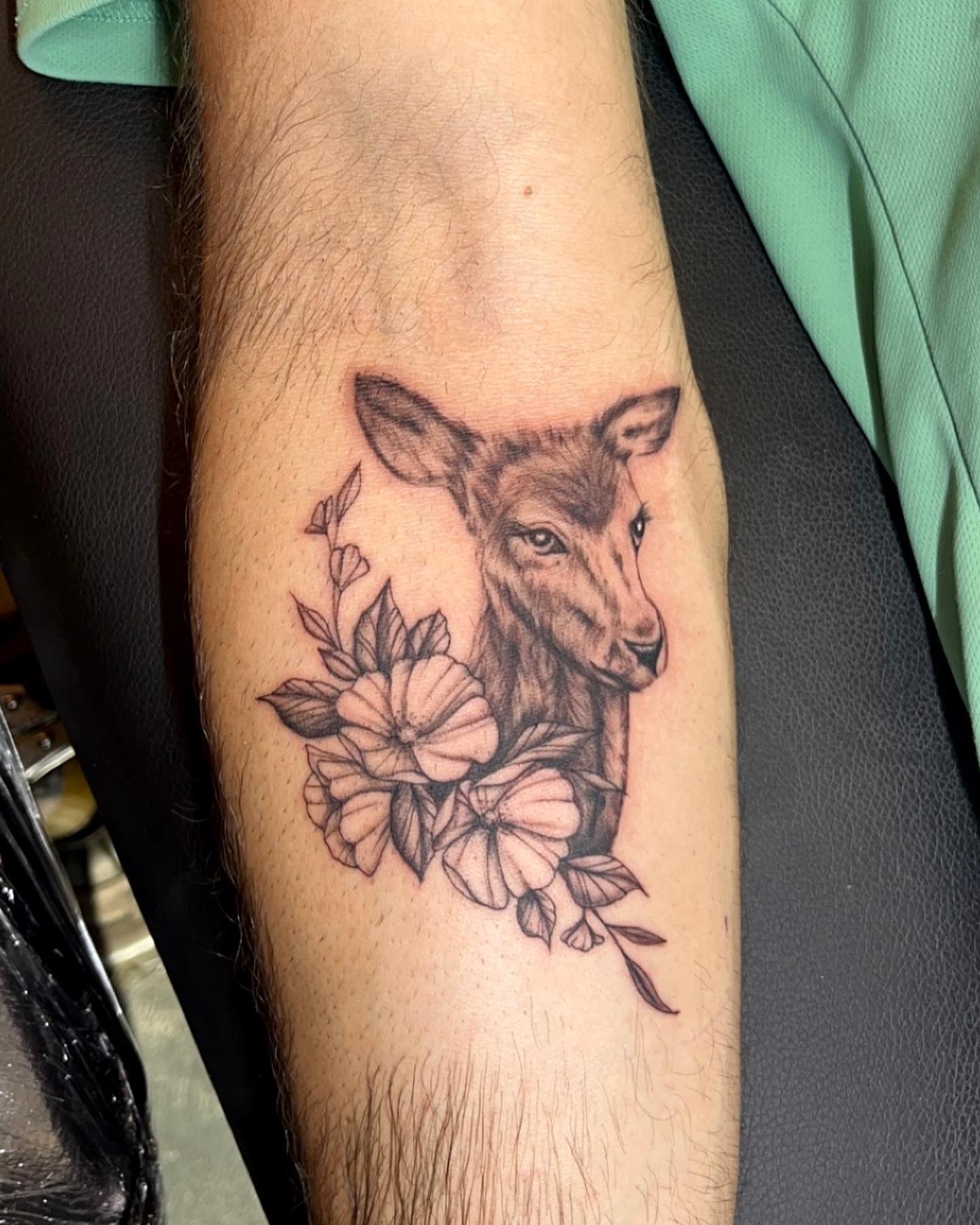 Deer and flowers realism tattoo on the forearm by Kenzie🖤