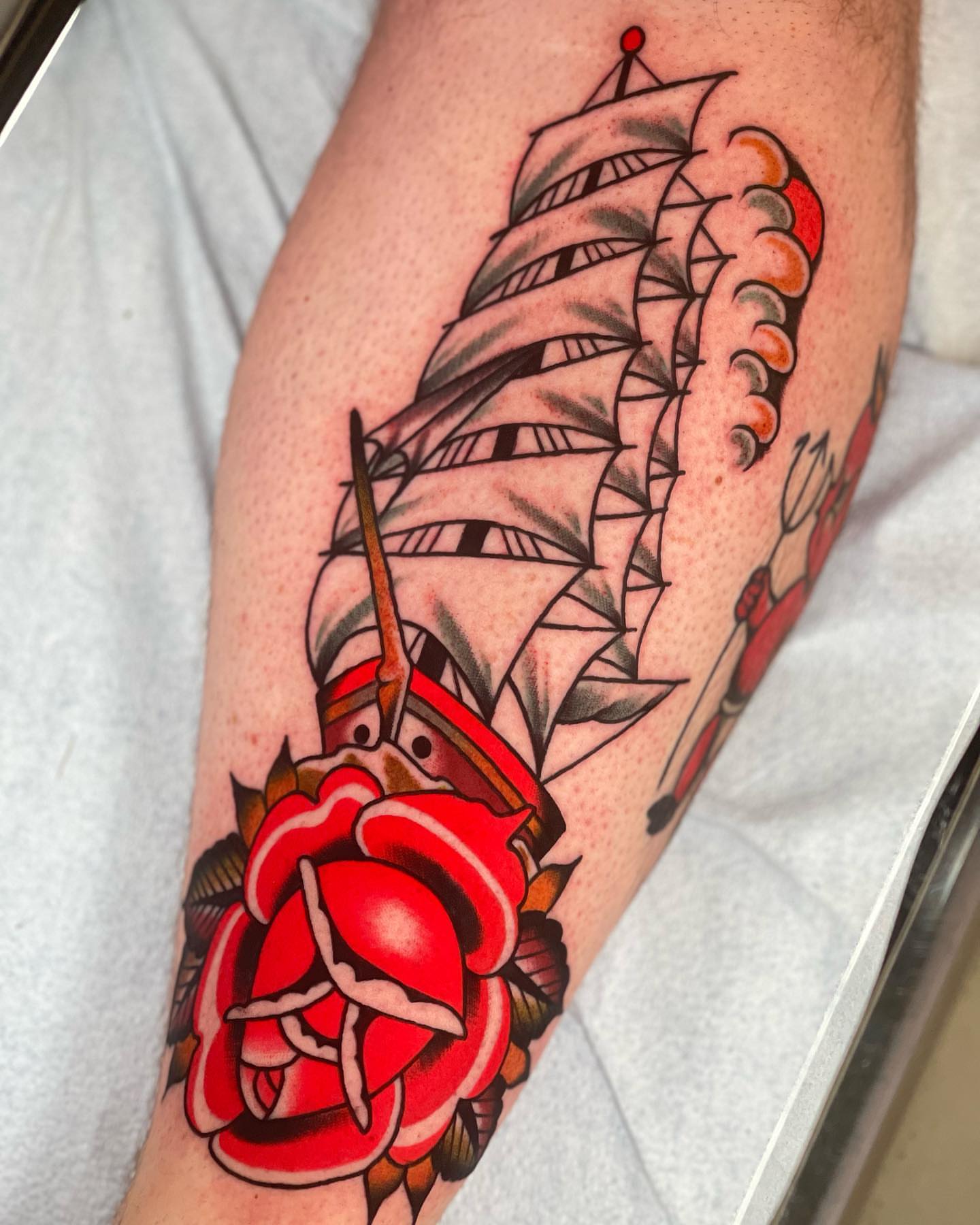 Sailboat and rose American traditional tattoo on the forearm by Jeff Miller philly traditional tattoo