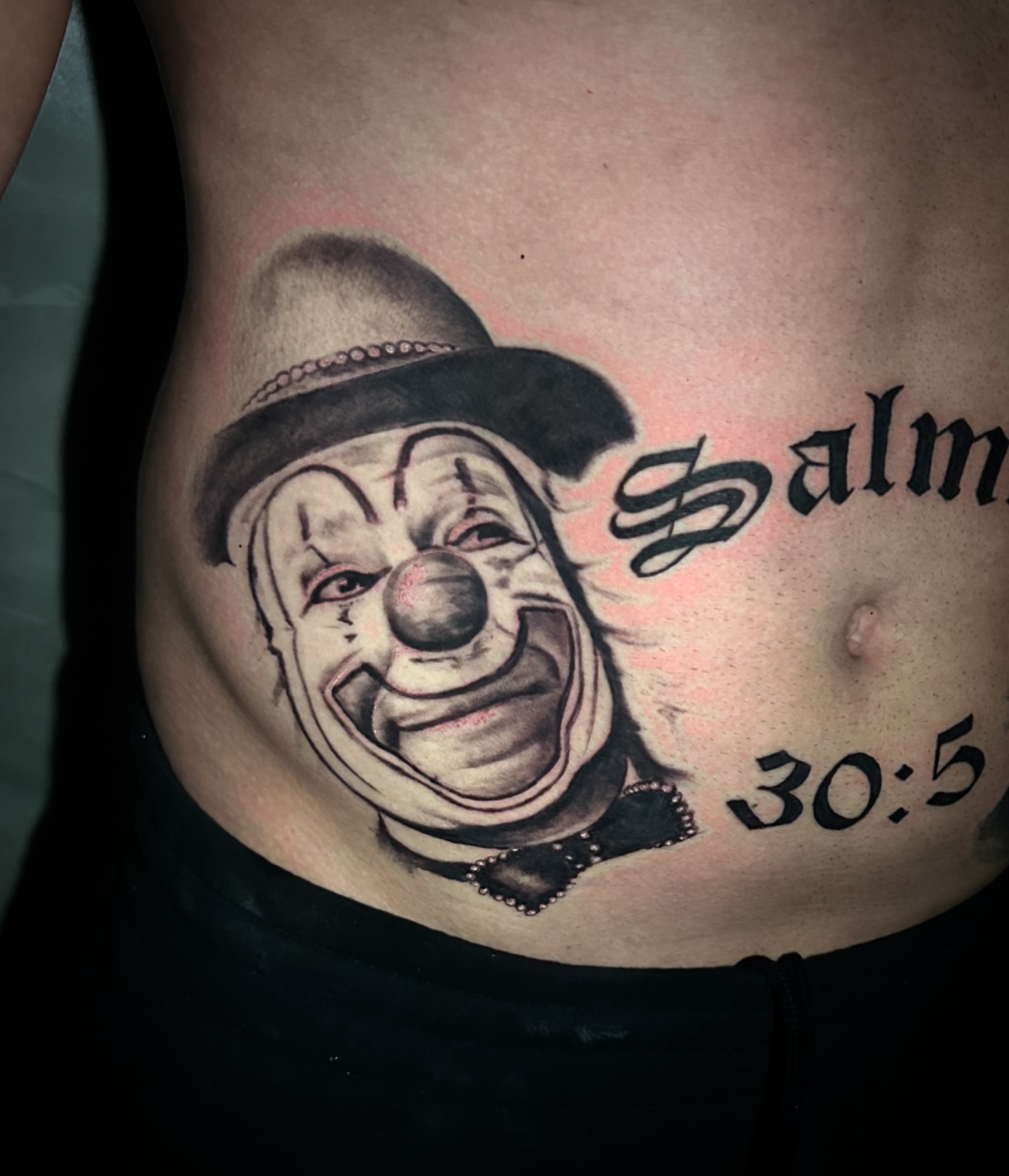 Clown black and grey tattoo on the torso by Tattoo Artist - the Goat