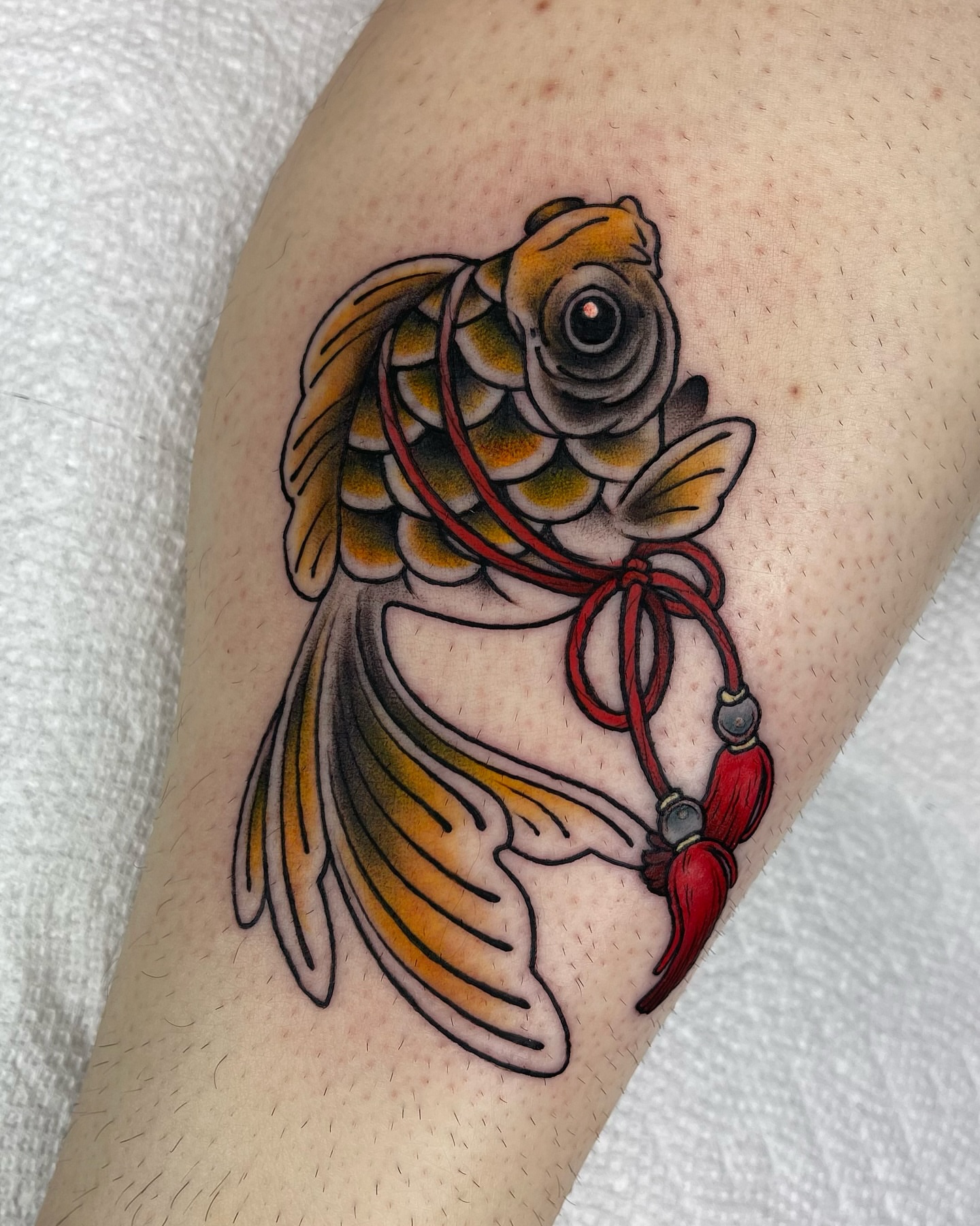 Koi fish American traditional tattoo on the forearm by Lexx Christine