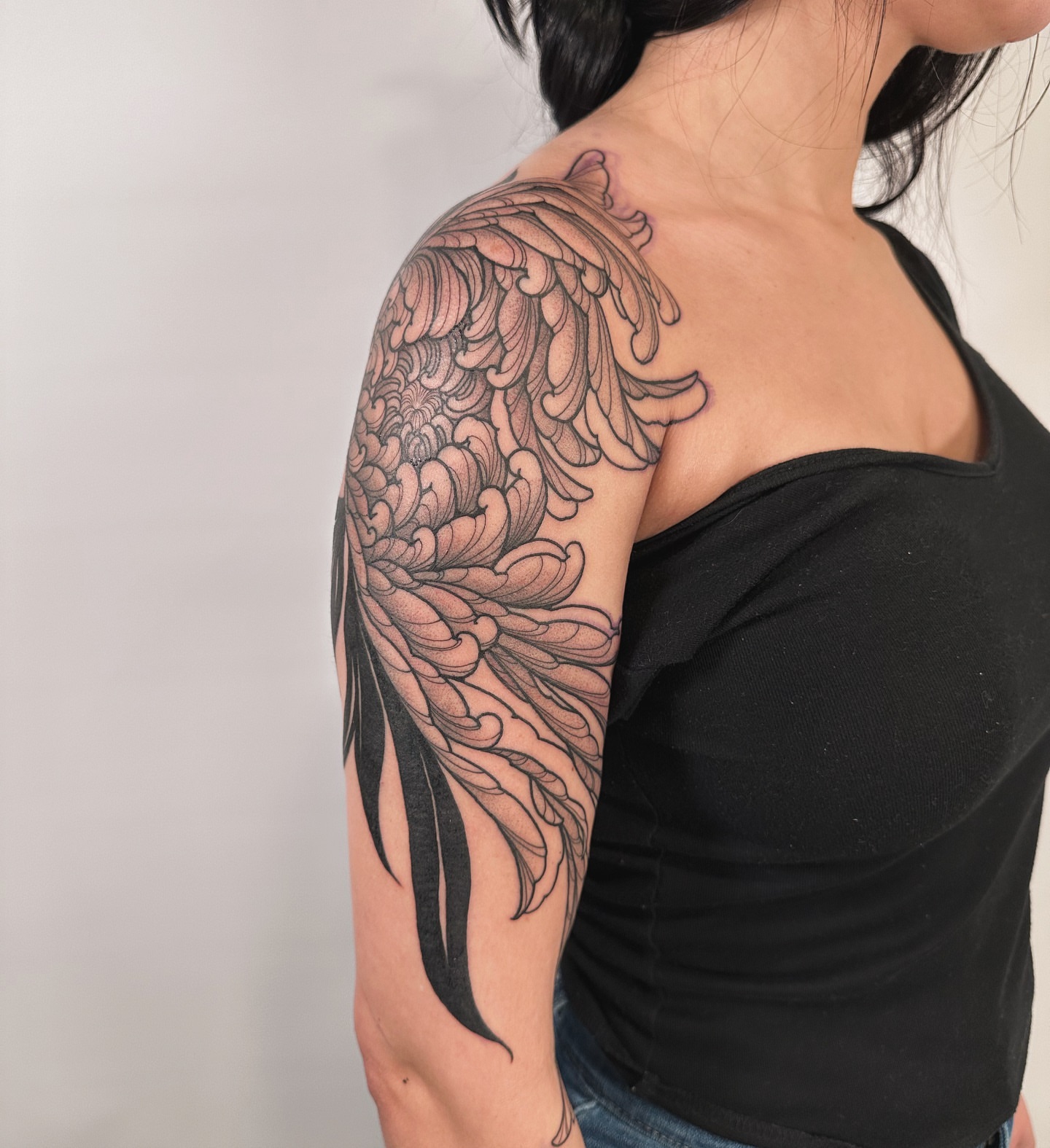 Wing black and grey tattoo on the upper arm by abigail 🌸