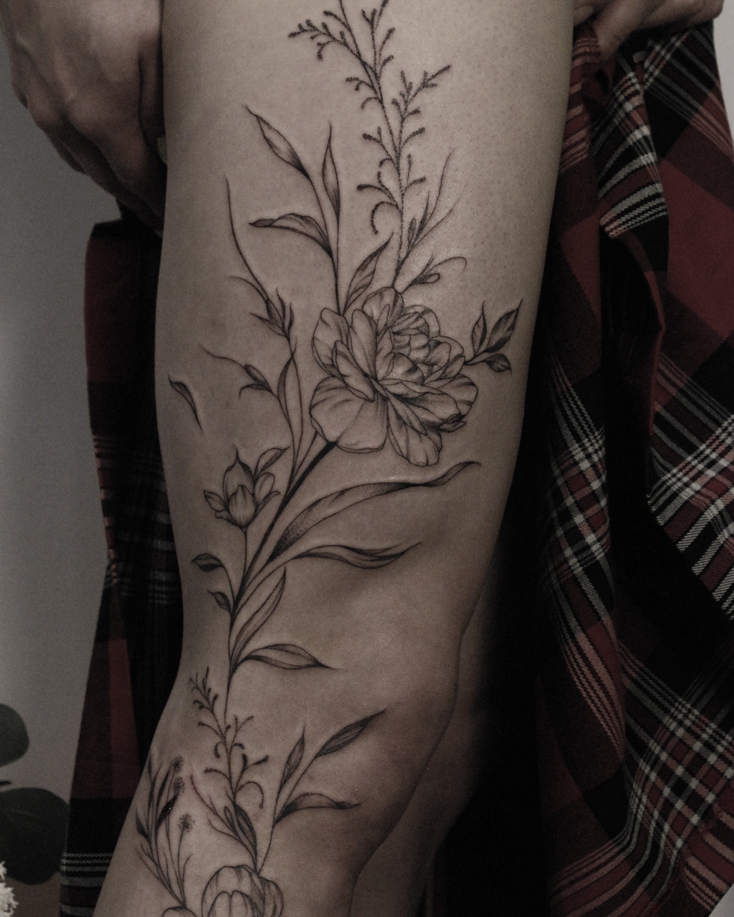 Floral design black and grey tattoo on the forearm by Seraphim