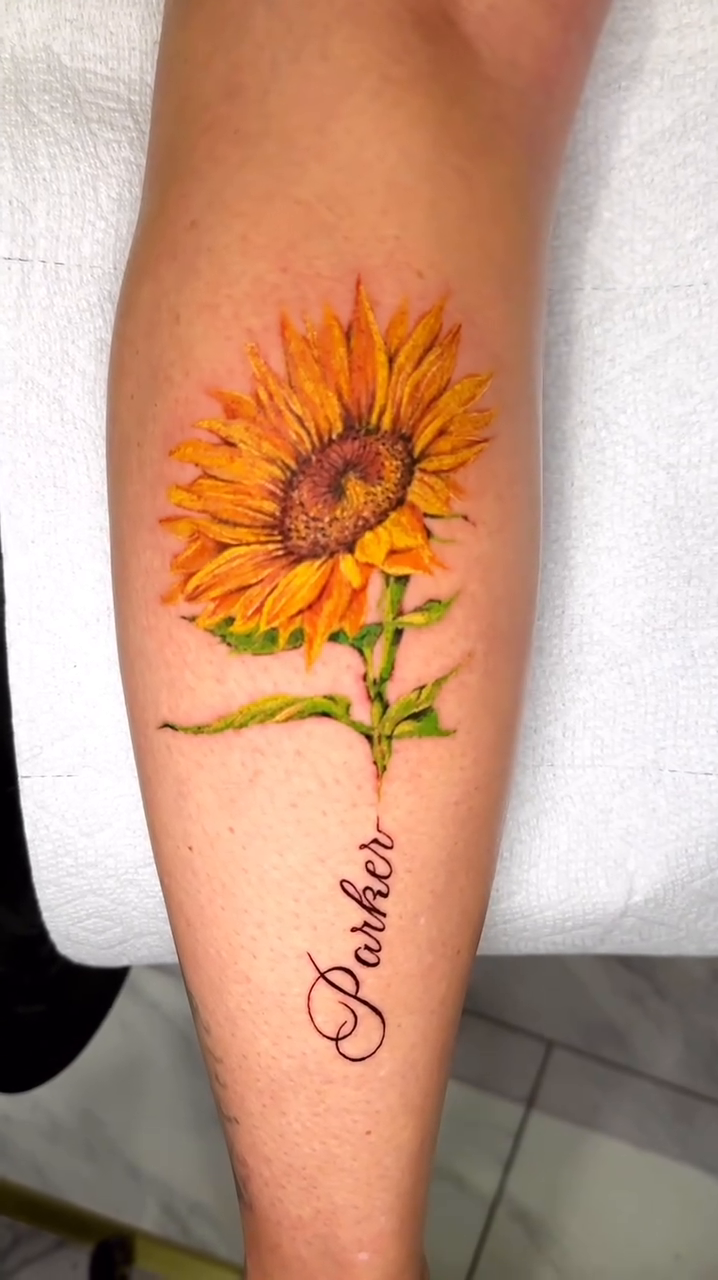 Sunflower with script name realism tattoo by Charlotte Tattoo Artist