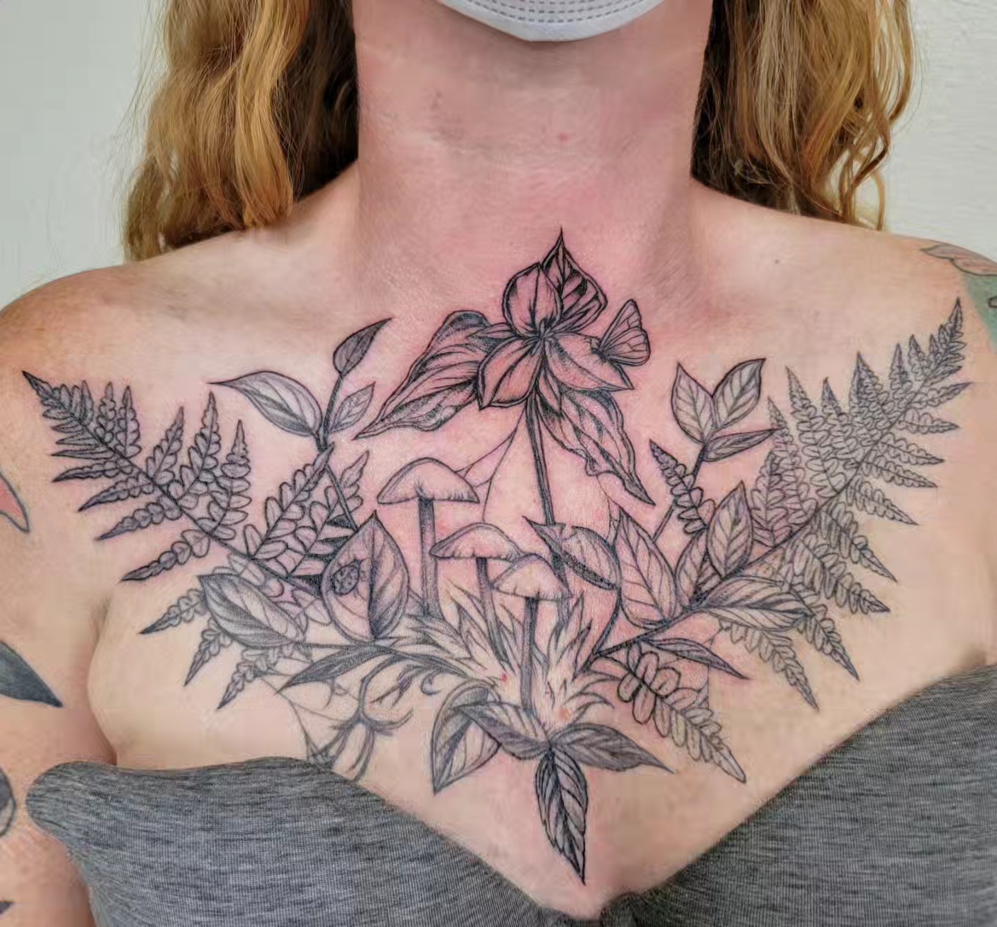 Floral arrangement black and grey tattoo on the chest by Sierra (cc) Klein