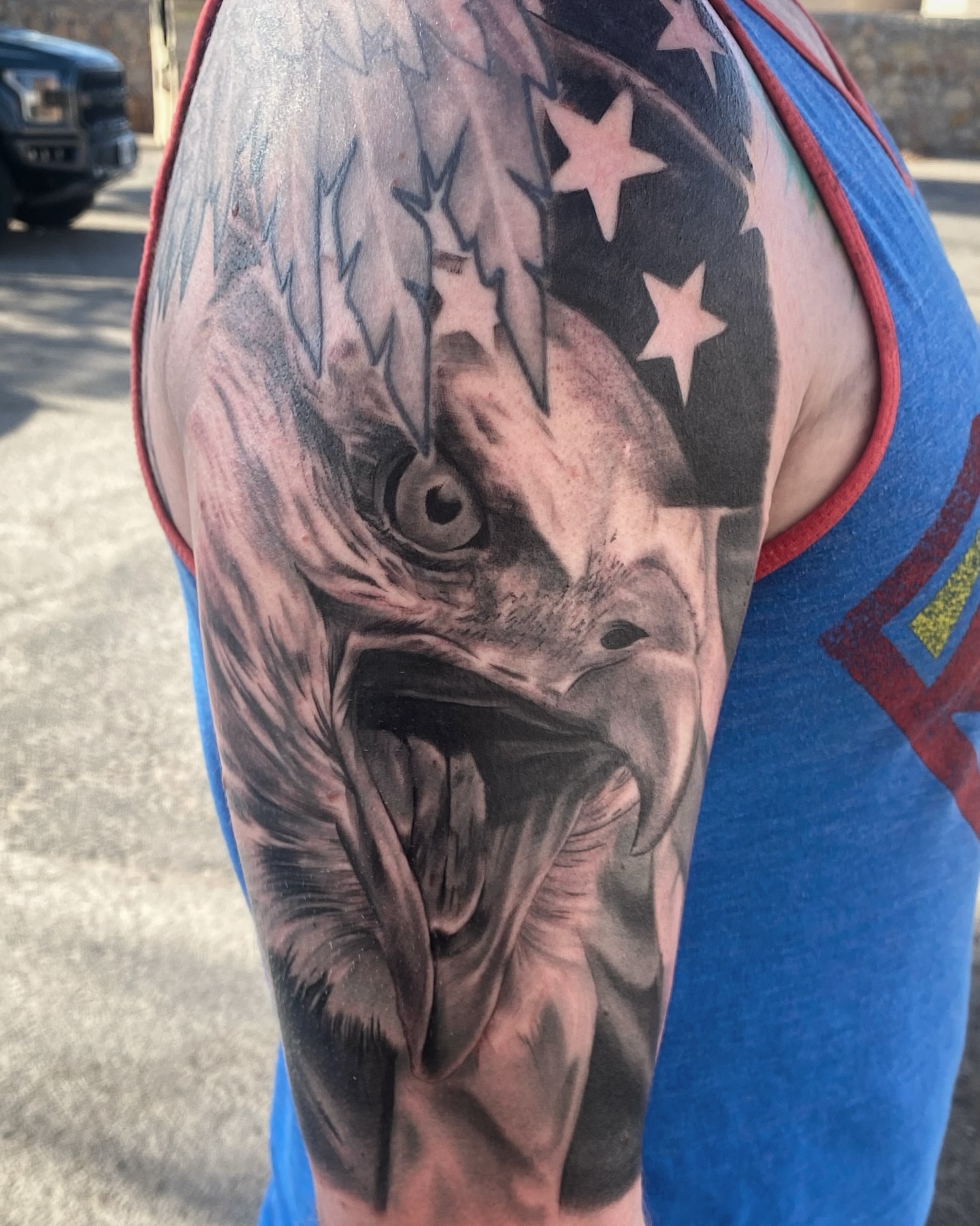 Eagle realism tattoo on the upper arm by Joseph Marshall