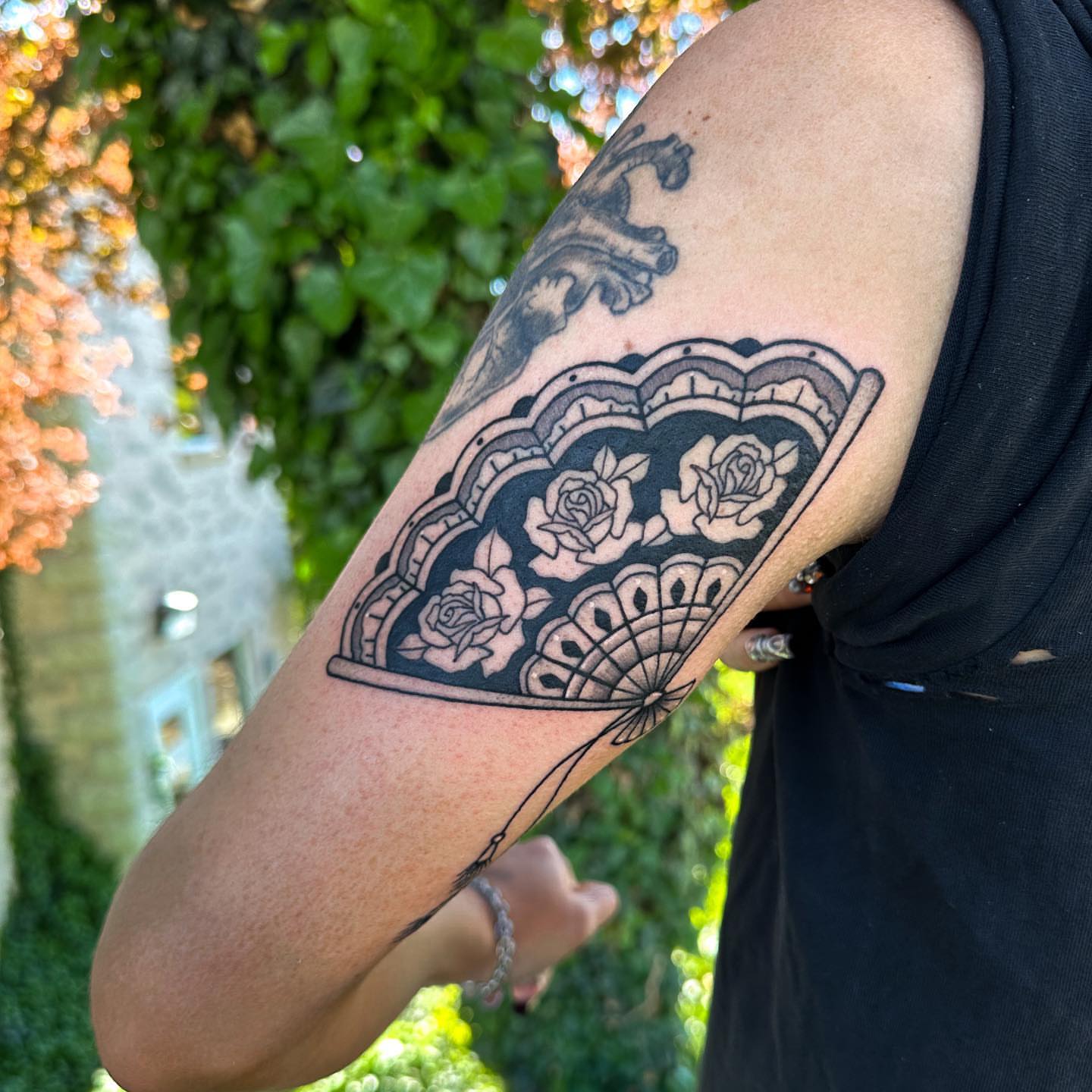 Lacy fan with roses geometric tattoo on the forearm by Gabby Tolley🌛