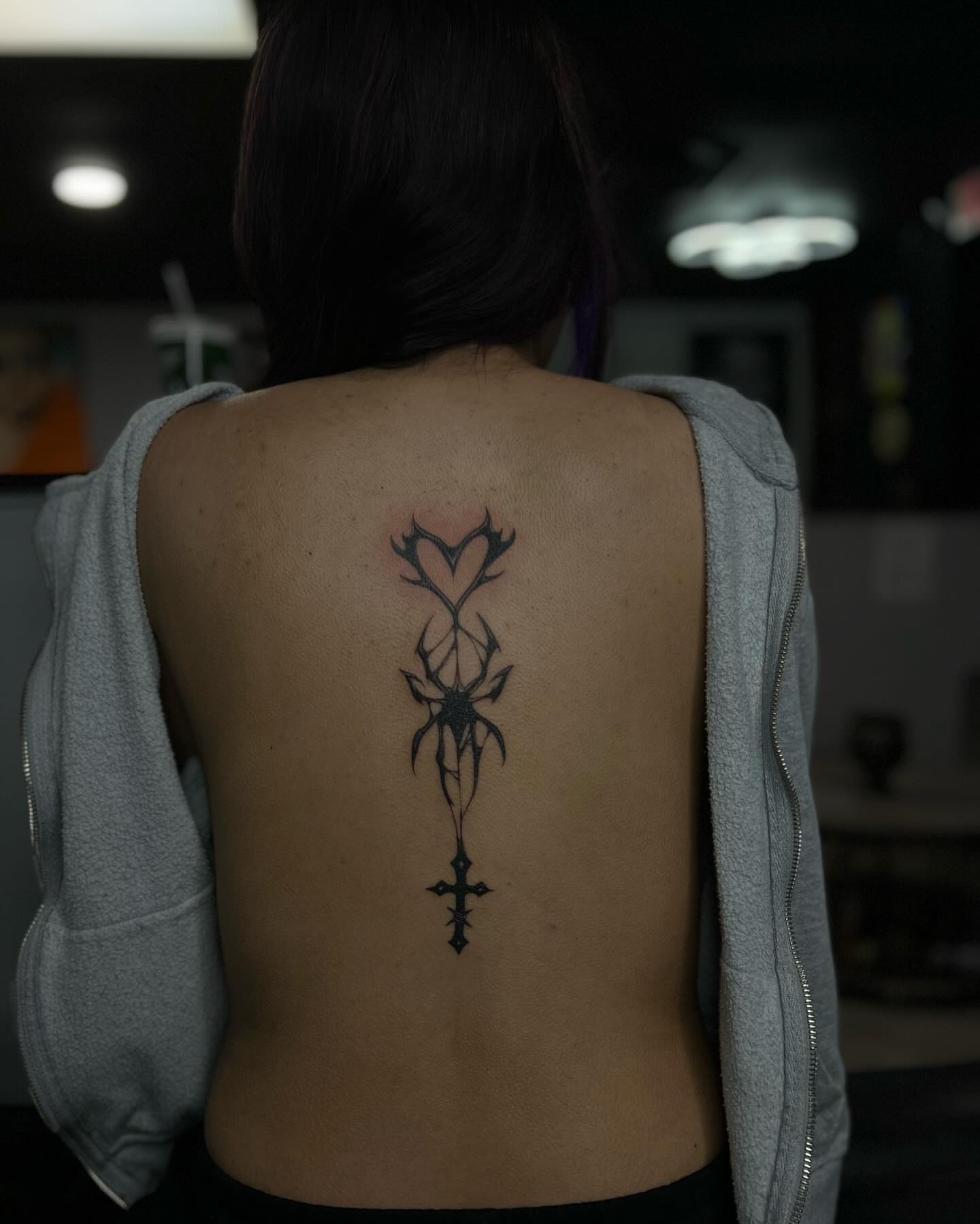 Cross with heart black and grey tattoo on the back by Alexa Camacho