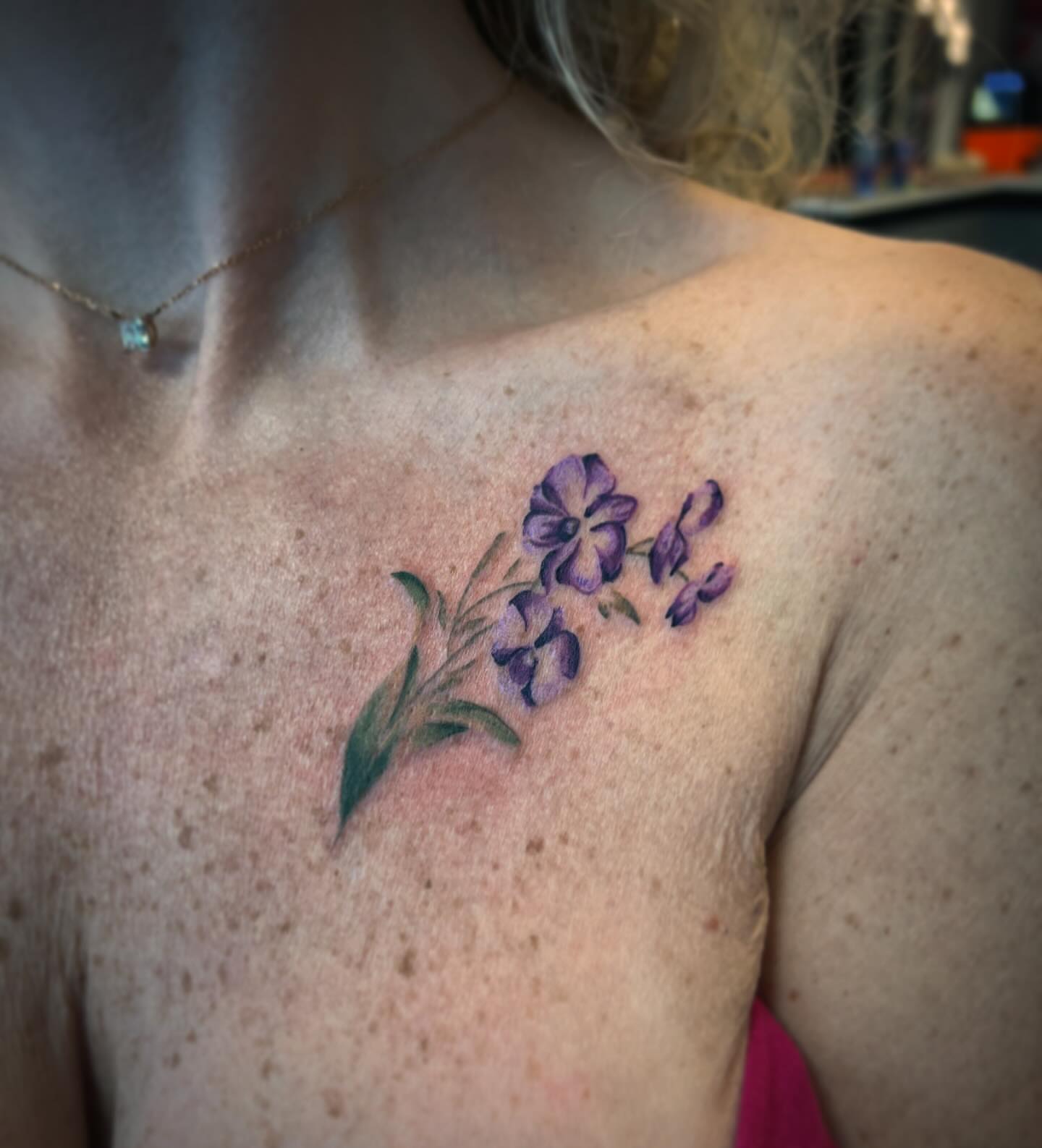 Purple flowers realism tattoo on the chest by Brooke, Kansas City, Missouri