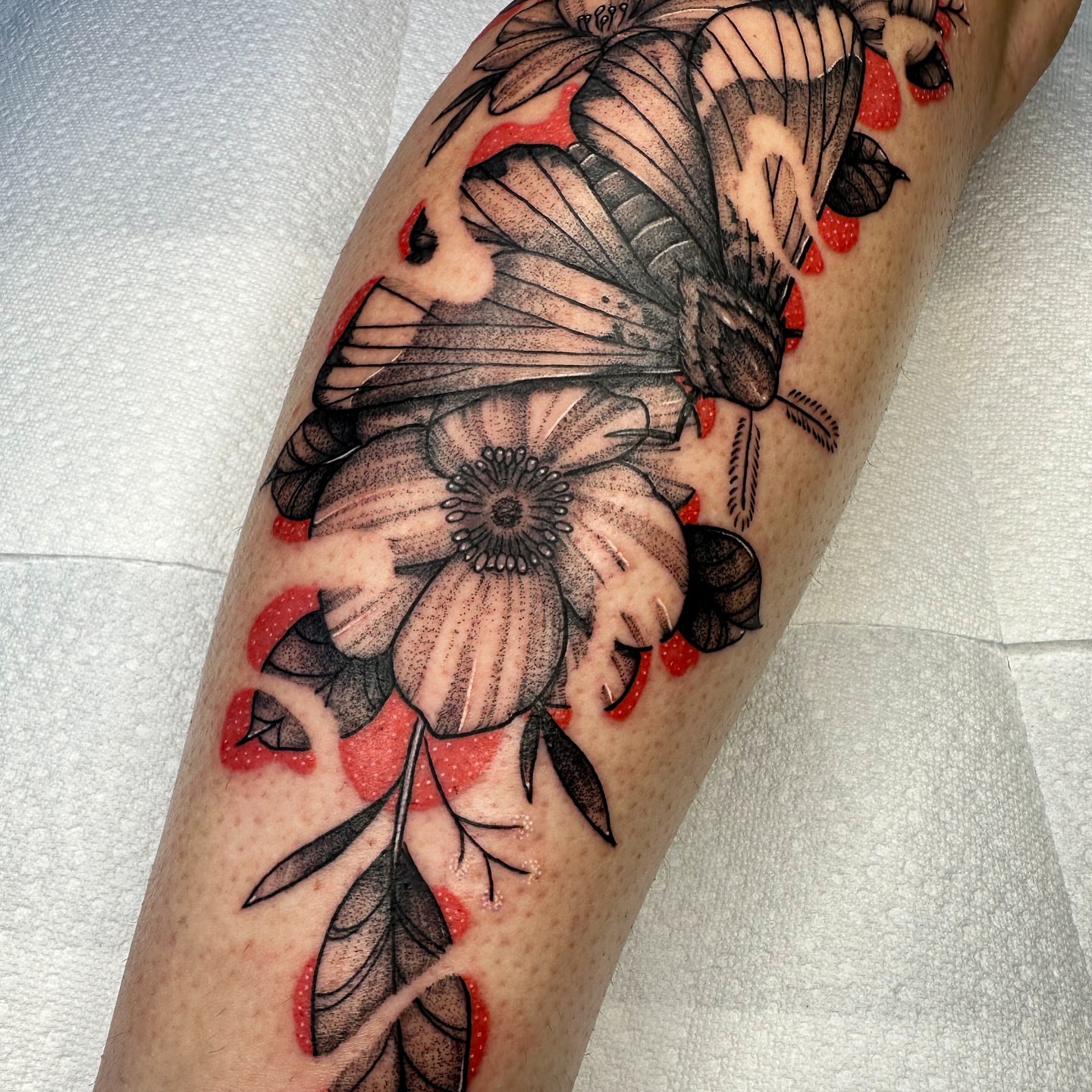 Butterfly and flower dotwork tattoo on the forearm by Tony Murray