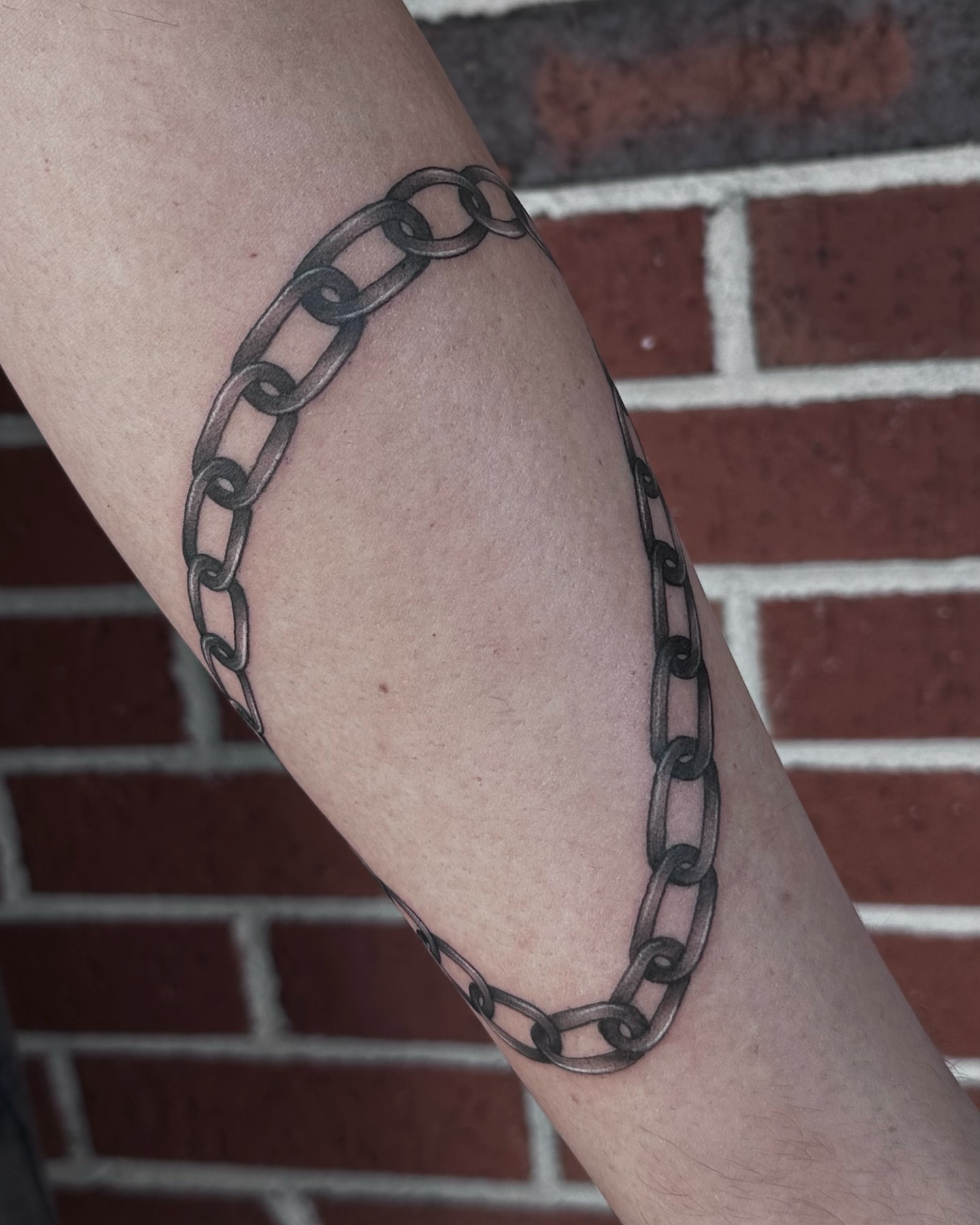Chain black and grey tattoo on the forearm by Rachel Martinez