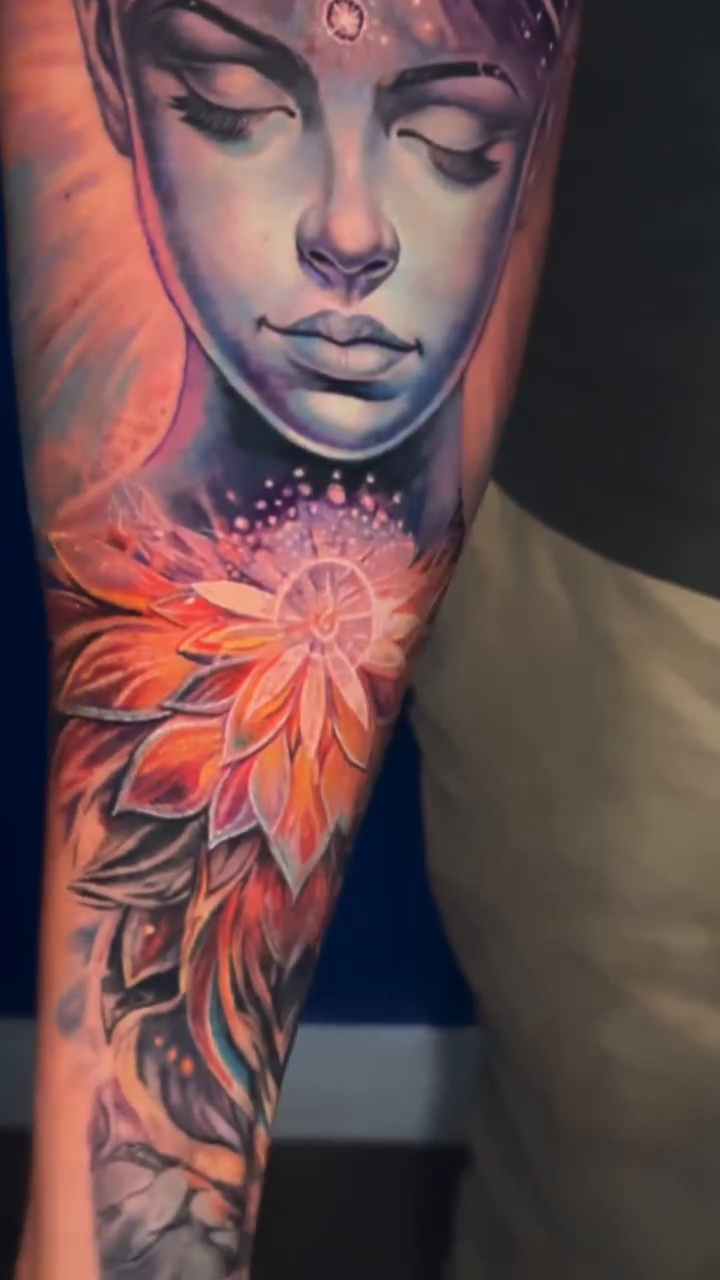 Woman with lotus flower realism tattoo by James Moyer