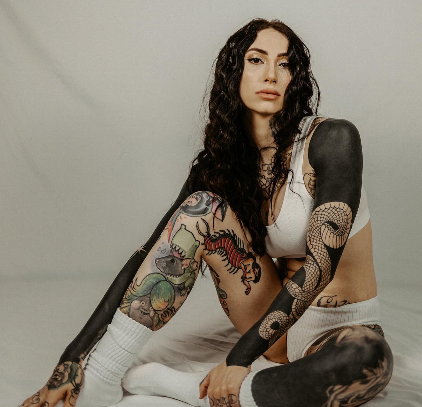 Tattooed woman American traditional tattoo on the upper arm by Briana Walker