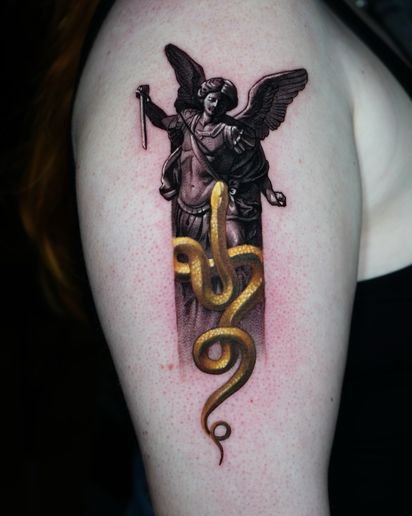 Statue with snake realism tattoo on the shoulder by Robert Morton, Cleveland, Ohio
