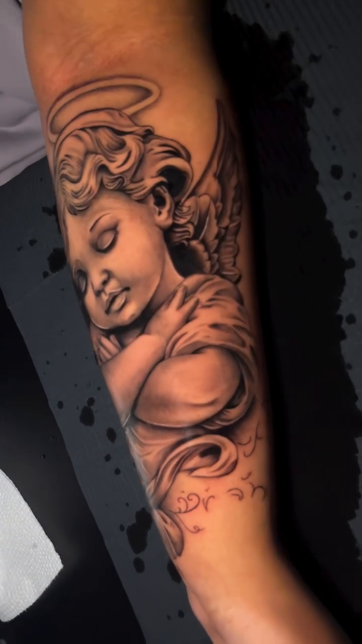 Cherub realism tattoo by TattooCrazy🎭
