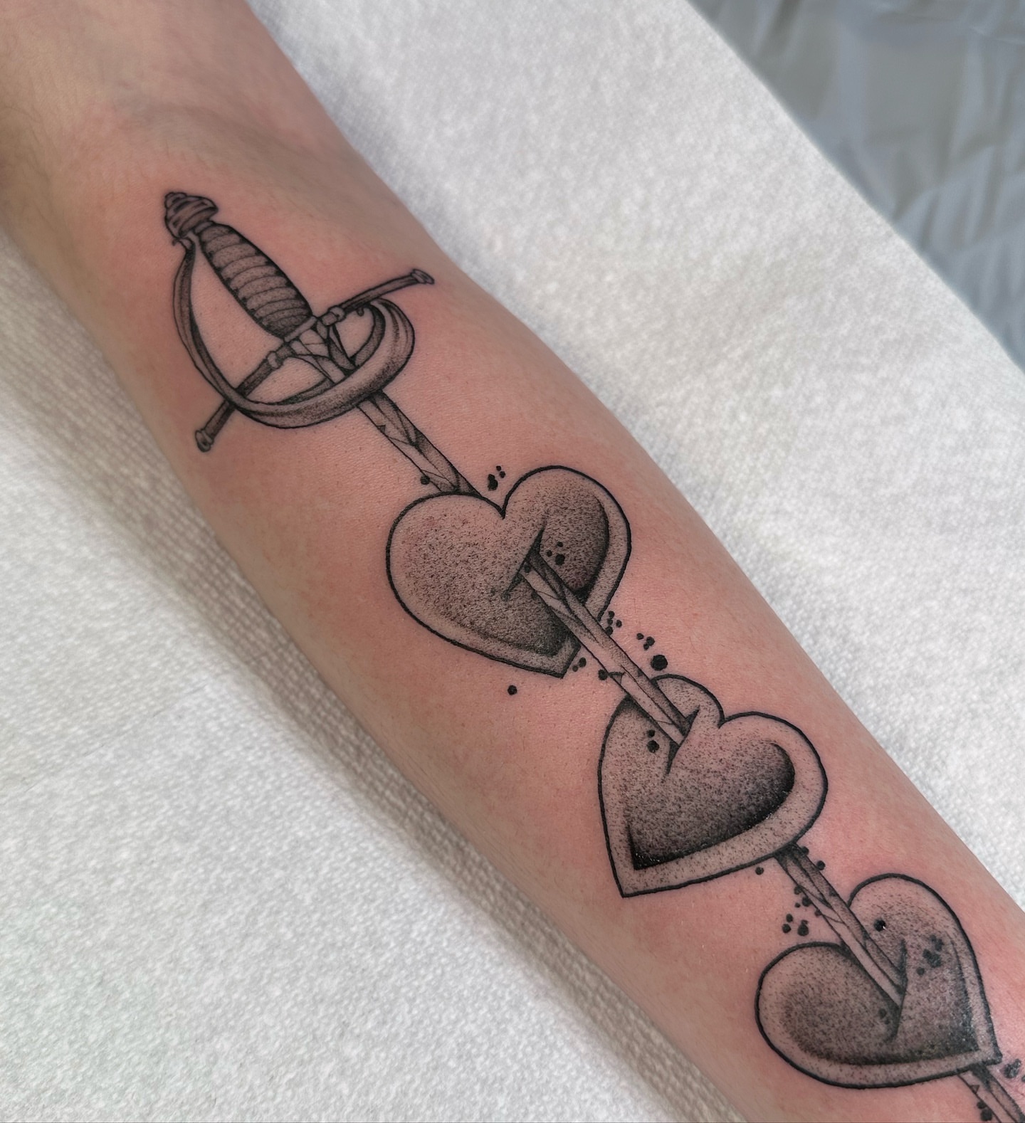 Sword through hearts dotwork tattoo on the forearm by abigail 🌸